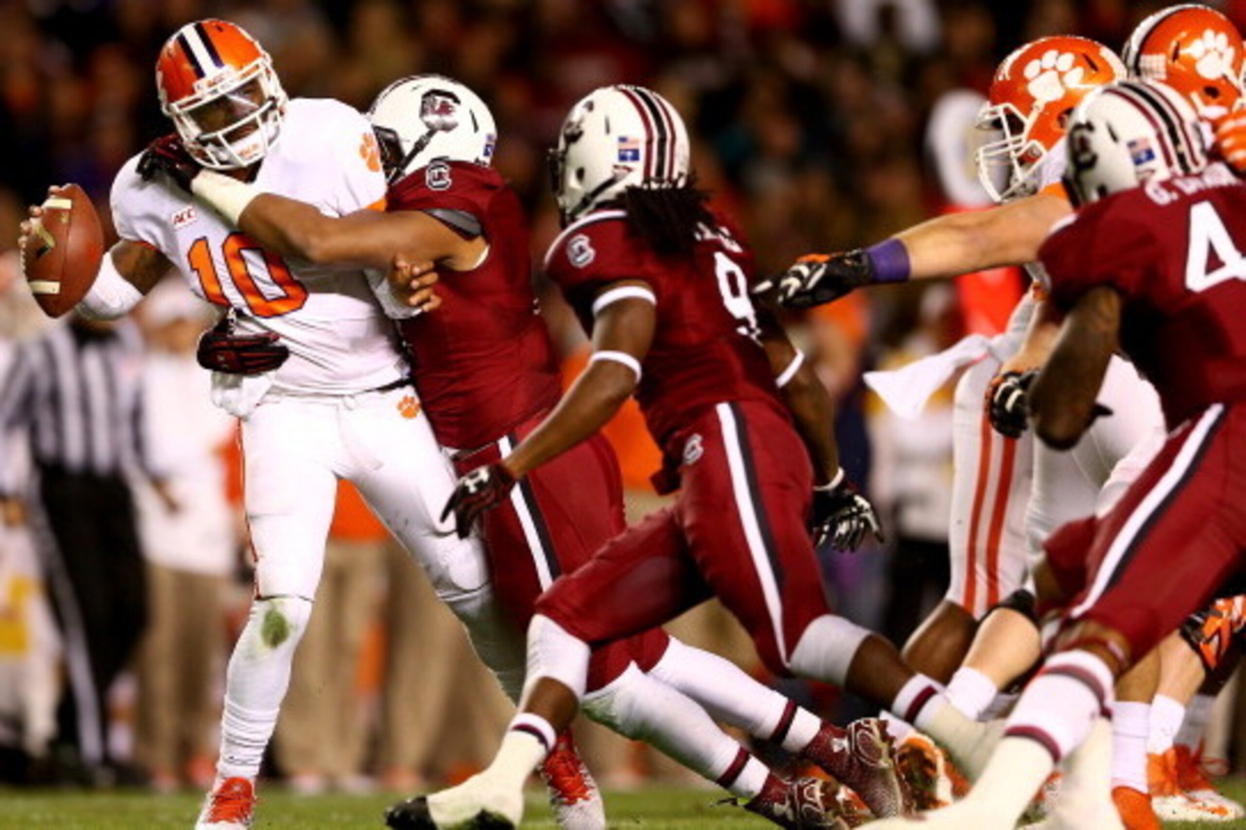 COLUMBIA, SC - NOVEMBER 30:  Tajh Boyd #10 of the Clemson Tigers is sacked by Kaiwan Lewis #8 of the South Carolina Gamecocks during their game at Williams-Brice Stadium on November 30, 2013 in Columbia, South Carolina.  (Photo by Streeter Lecka/Getty Ima