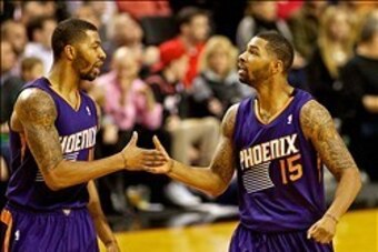 Nov 13, 2013; Portland, OR, USA; Phoenix Suns power forward Marcus Morris (15) and power forward Markieff Morris (11) high five after scoring against the Portland Trail Blazers at the Moda Center. Mandatory Credit: Craig Mitchelldyer-USA TODAY Sports