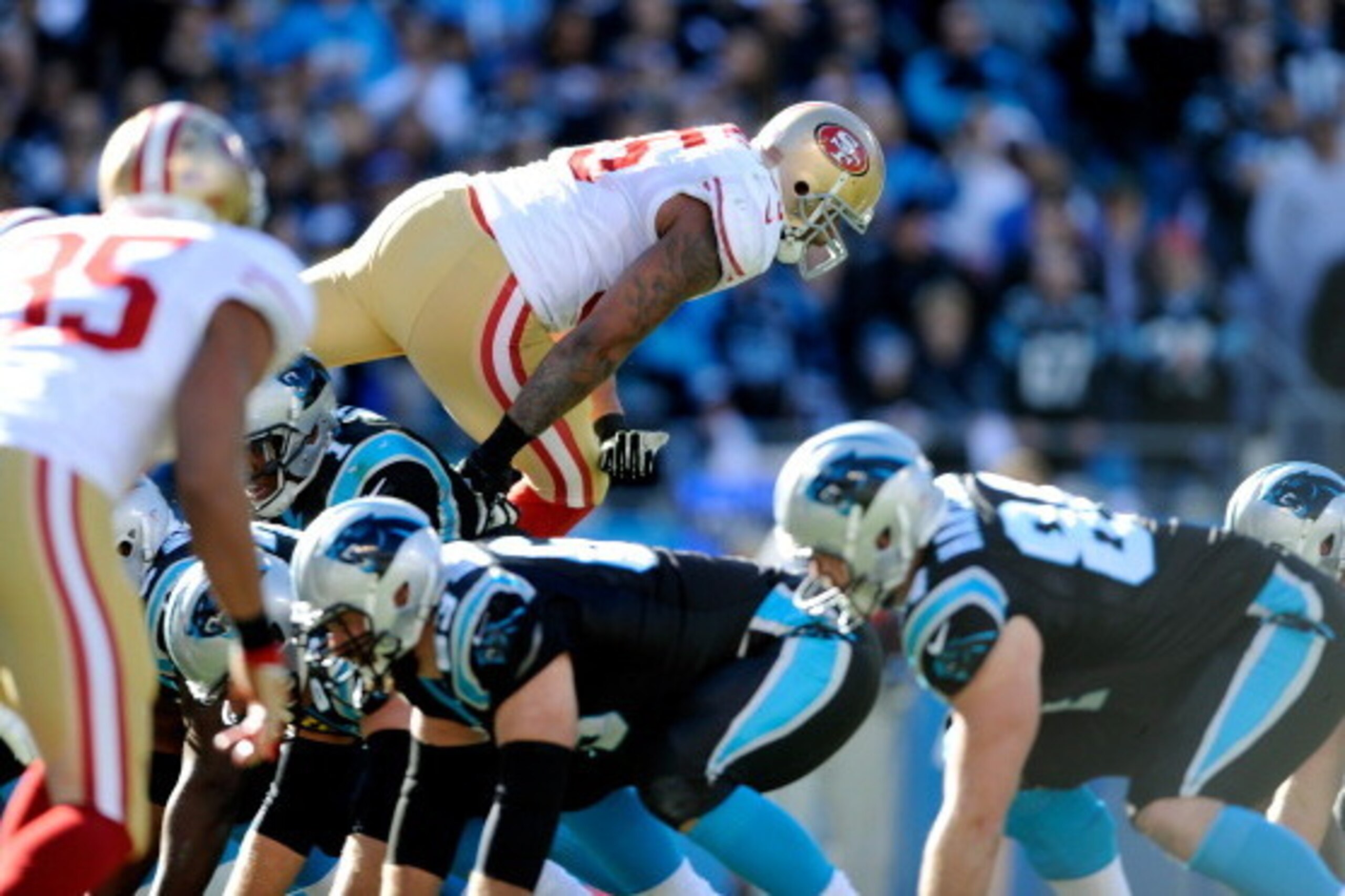 CHARLOTTE, NC - JANUARY 12: Ahmad Brooks #55 of the San Francisco 49ers jumps over the offensive line of the Carolina Panthers in the second quarter during the NFC Divisional Playoff Game at Bank of America Stadium on January 12, 2014 in Charlotte, North 