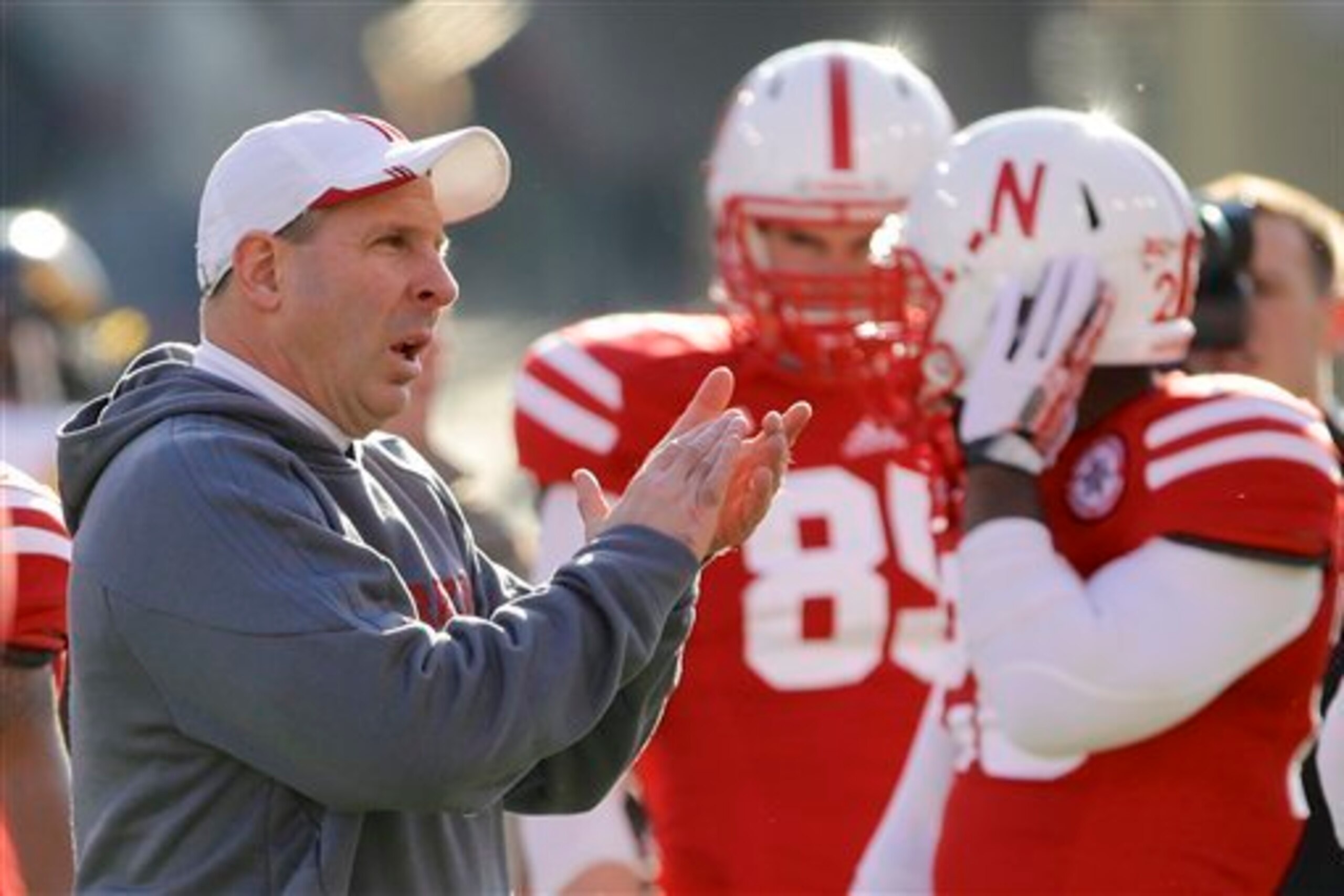 Nebraska head coach Bo Pelini visits with players during warmups as Iowa and Nebraska prepare to square off in an NCAA college football game in Lincoln, Neb., Friday, Nov. 29, 2013. (AP Photo/Nati Harnik)