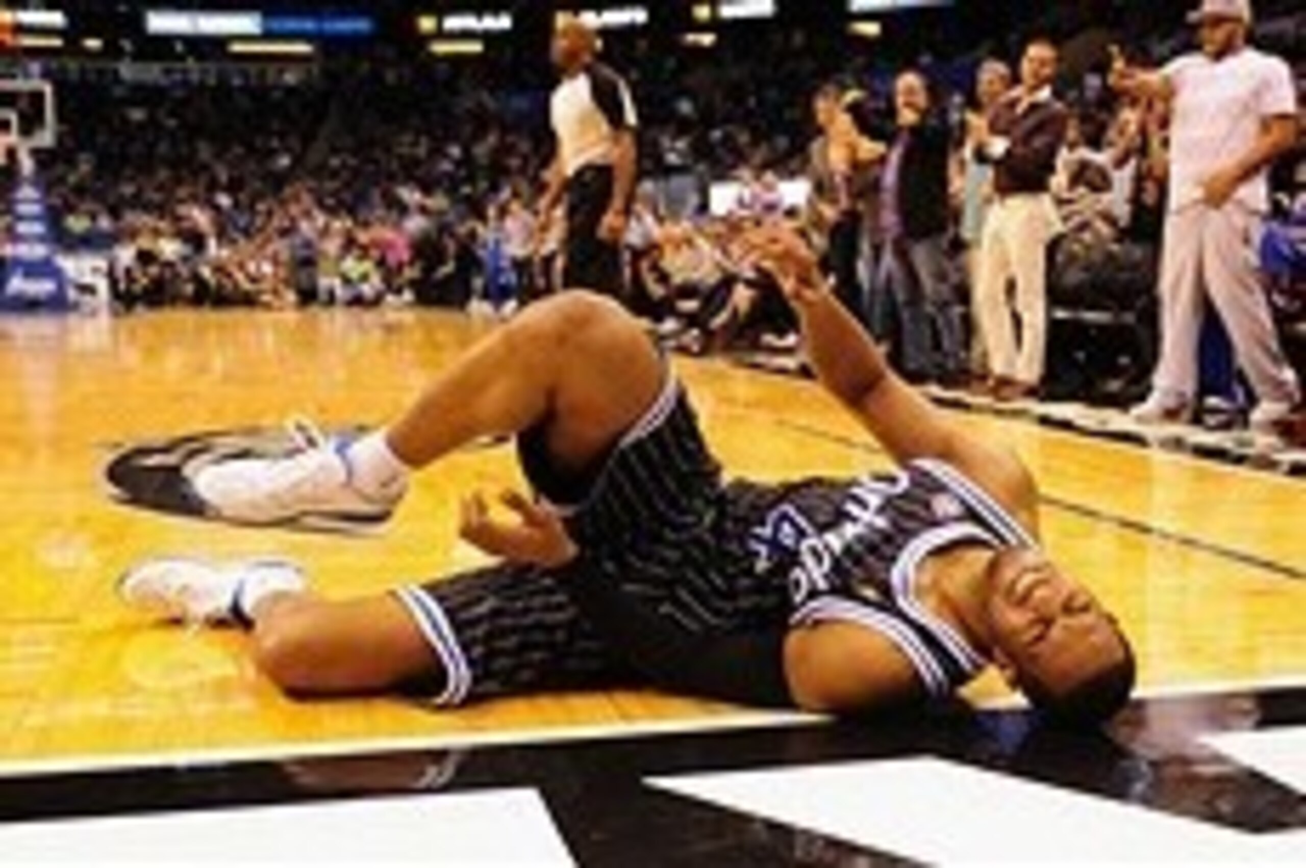 Feb 21, 2014; Orlando, FL, USA; Orlando Magic shooting guard Arron Afflalo (4) lies on the ground in pain after an injury with 2:23 to go in double overtime as the Orlando Magic beat the New York Knicks 129-121 in double overtime at Amway Center. Afflalo 