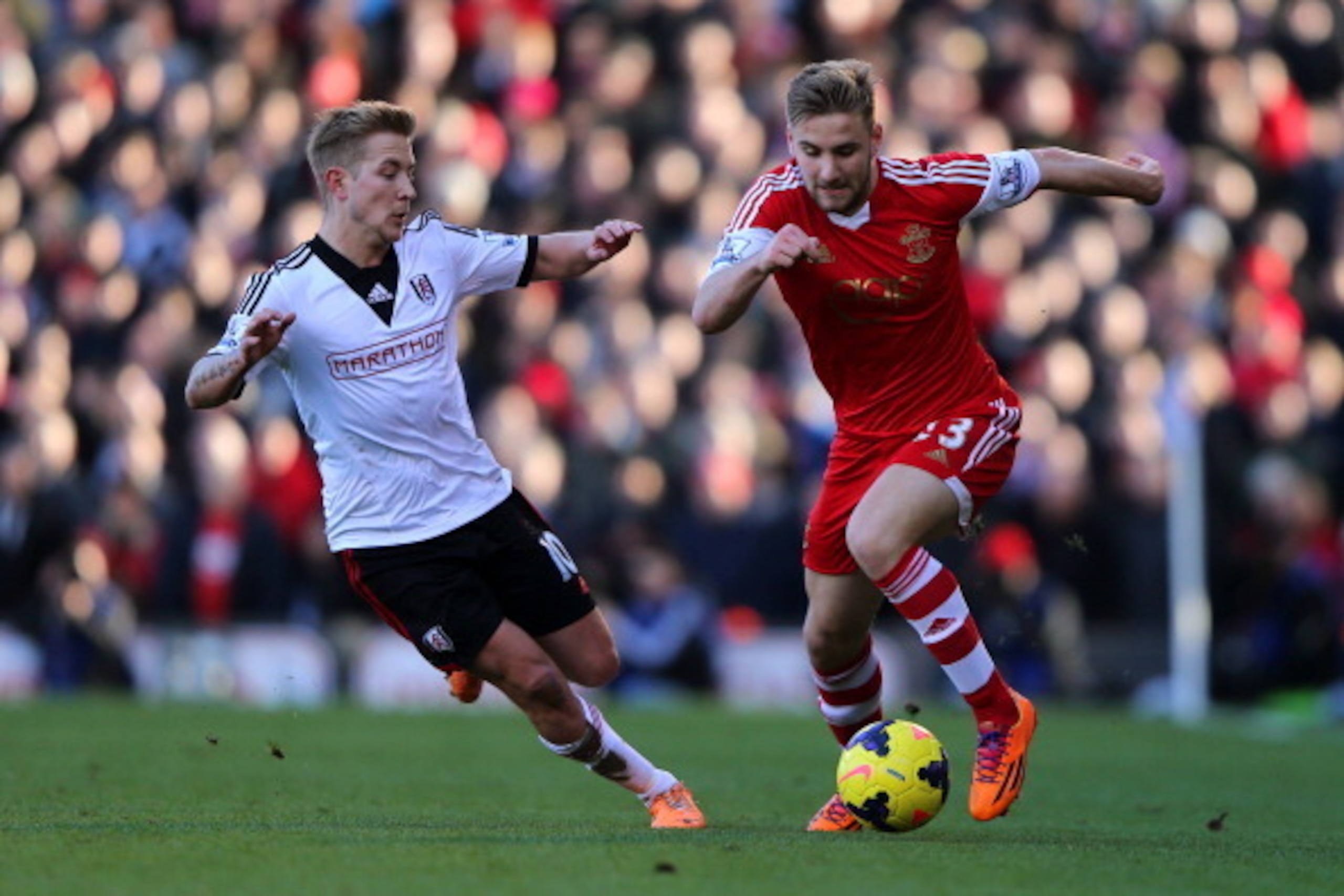 LONDON, ENGLAND - FEBRUARY 01:  Luke Shaw of Southampton in action against Lewis Holtby of Fulham during the Barclays Premier League match between Fulham and Southampton at Craven Cottage on February 1, 2014 in London, England.  (Photo by Ian Walton/Getty