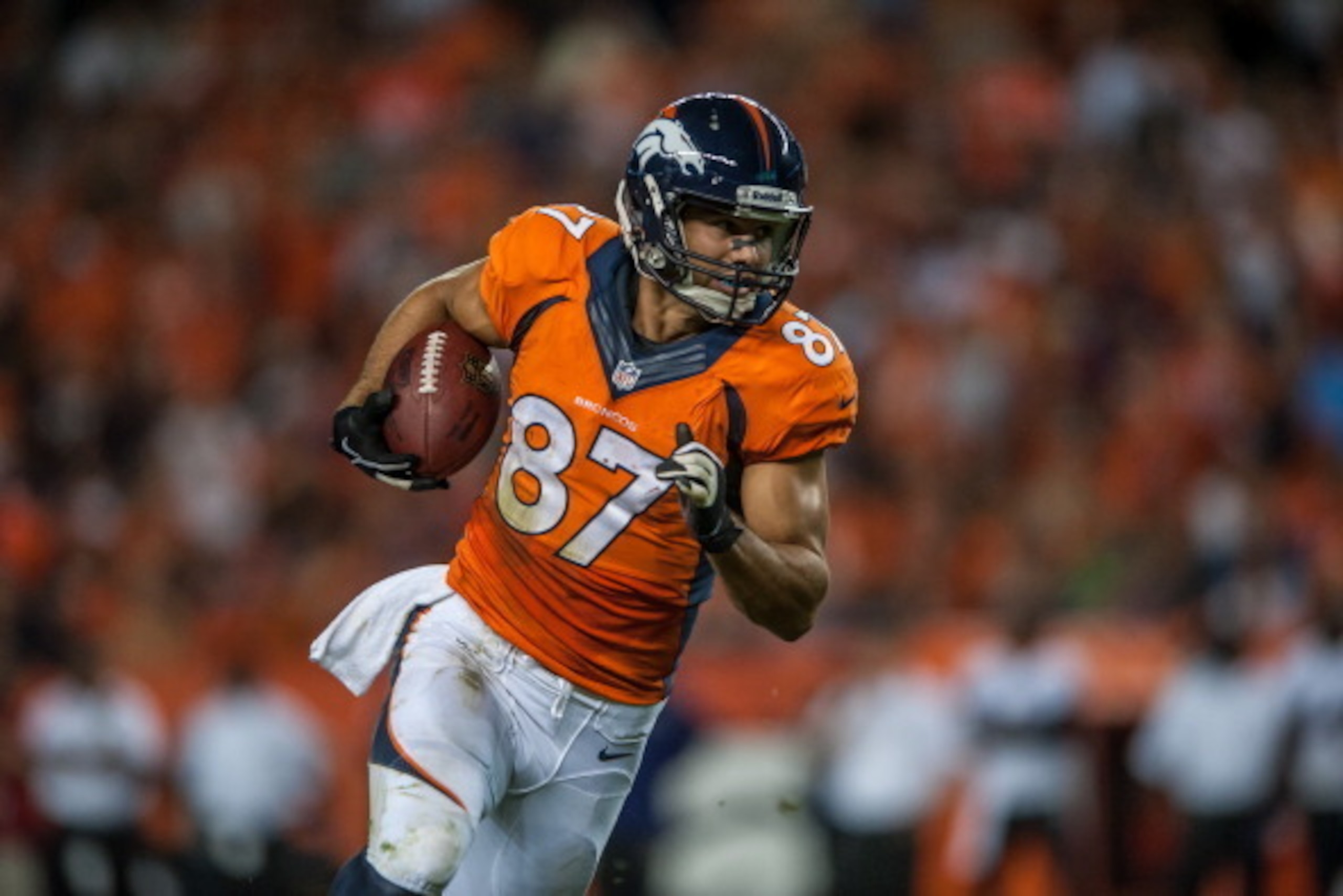 DENVER, CO - SEPTEMBER 5:  Wide receiver Eric Decker #87 of the Denver Broncos runs for yards after the catch against the Baltimore Ravensduring the game at Sports Authority Field at Mile High on September 5, 2013 in Denver Colorado. (Photo by Dustin Brad