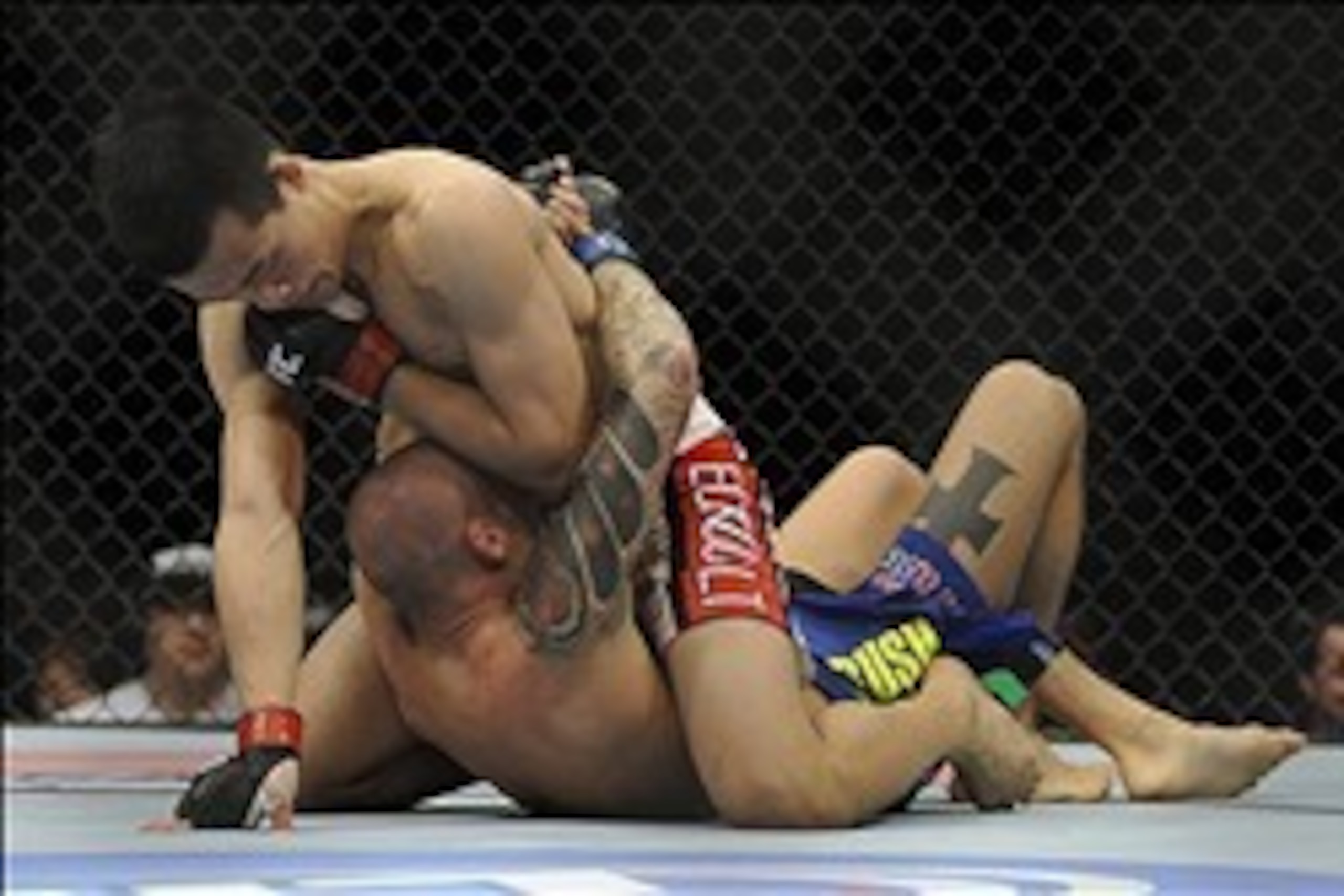 May 15, 2012; Fairfax, VA, USA; The Korean Zombie (top) lands an elbow to the temple of Dustin Poirier (bottom) during the Korean zombie vs Poirier event at Patriot Center.  Mandatory Credit: Rafael Suanes-USA TODAY Sports
