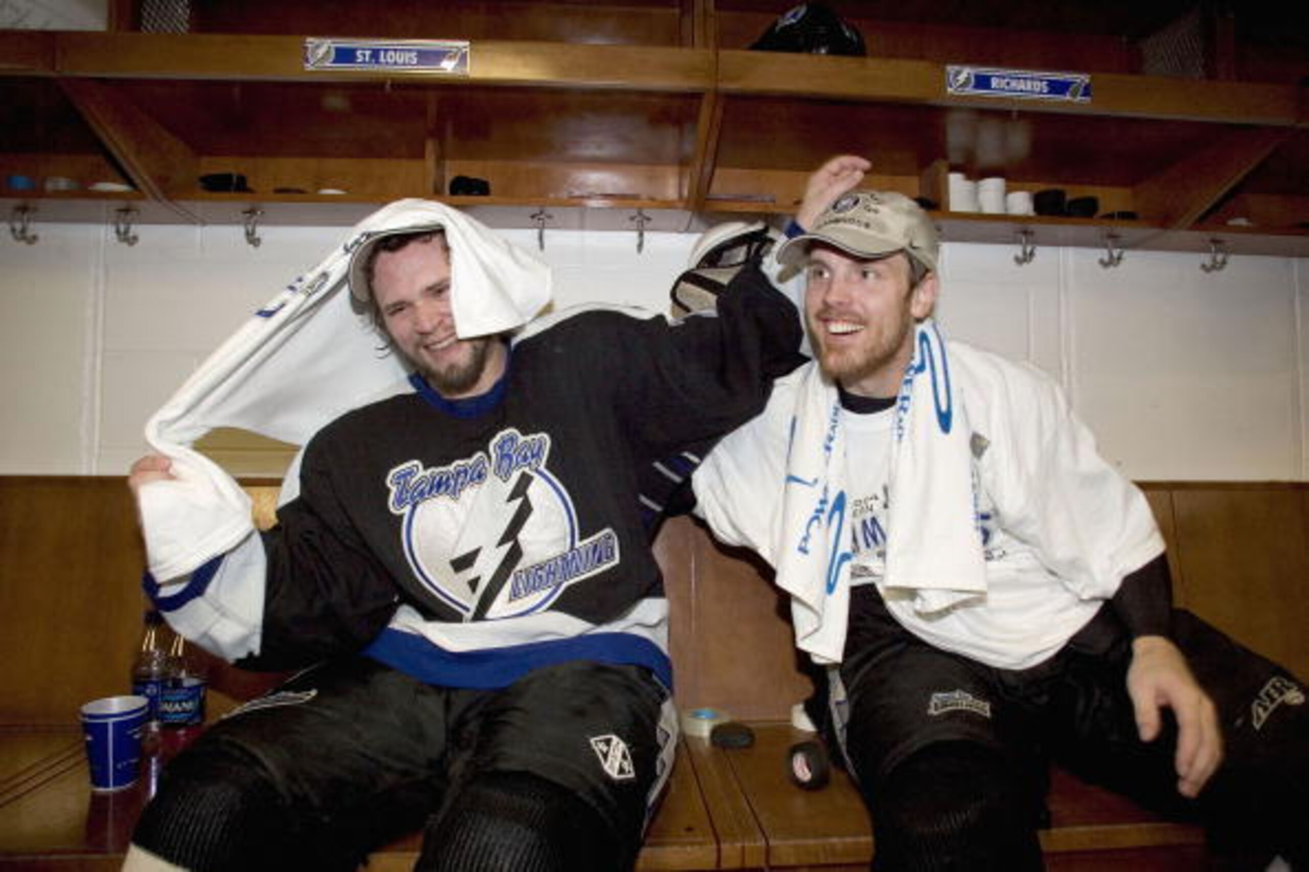 TAMPA, FL - MAY 22:  Martin St. Louis #26 and teammate Brad Richards #19 of the Tampa Bay Lightning celebrate in the locker room after defeating the Philadelphia Flyers in game seven of the NHL Eastern Conference Finals on May 22, 2004 at the St. Pete Tim
