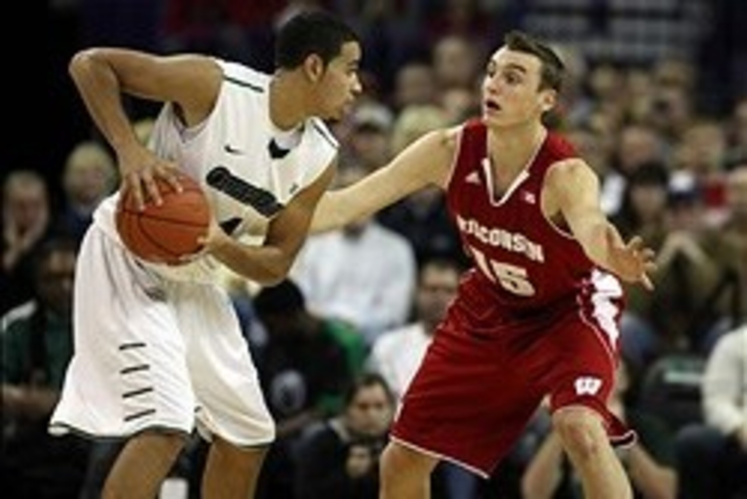 Nov 16, 2013; Green Bay, WI, USA; Wisconsin-Green Bay Phoenix guard Jordan Fouse (4) looks to pass as Wisconsin Badgers forward Sam Dekker (15) defends at the Resch Center in Ashwaubenon. The Wisconsin Badgers defeated Wisconsin-Green Bay 69-66.  Mandator
