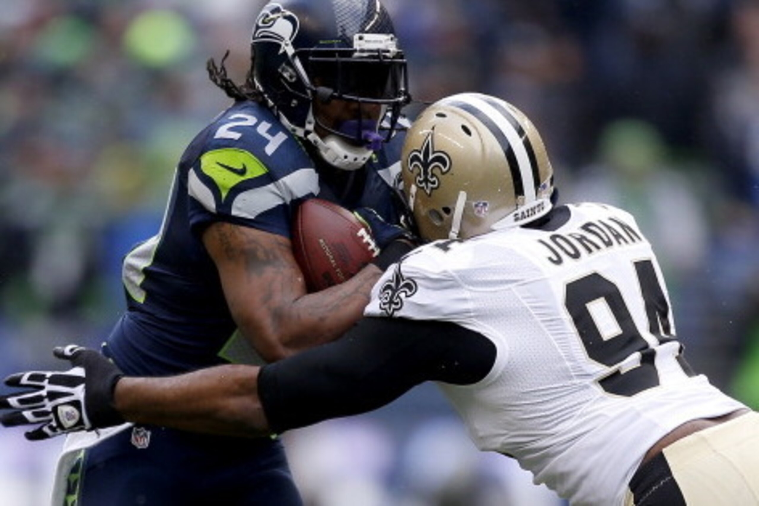 SEATTLE, WA - JANUARY 11: Running back Marshawn Lynch #24 of the Seattle Seahawks runs the ball against defensive end Cameron Jordan #94 of the New Orleans Saints in the first quarter during the NFC Divisional Playoff Game at CenturyLink Field on January SEATTLE, WA - JANUARY 11: Running back Marshawn Lynch #24 of the Seattle Seahawks runs the ball against defensive end Cameron Jordan #94 of the New Orleans Saints in the first quarter during the NFC Divisional Playoff Game at CenturyLink Field on January
