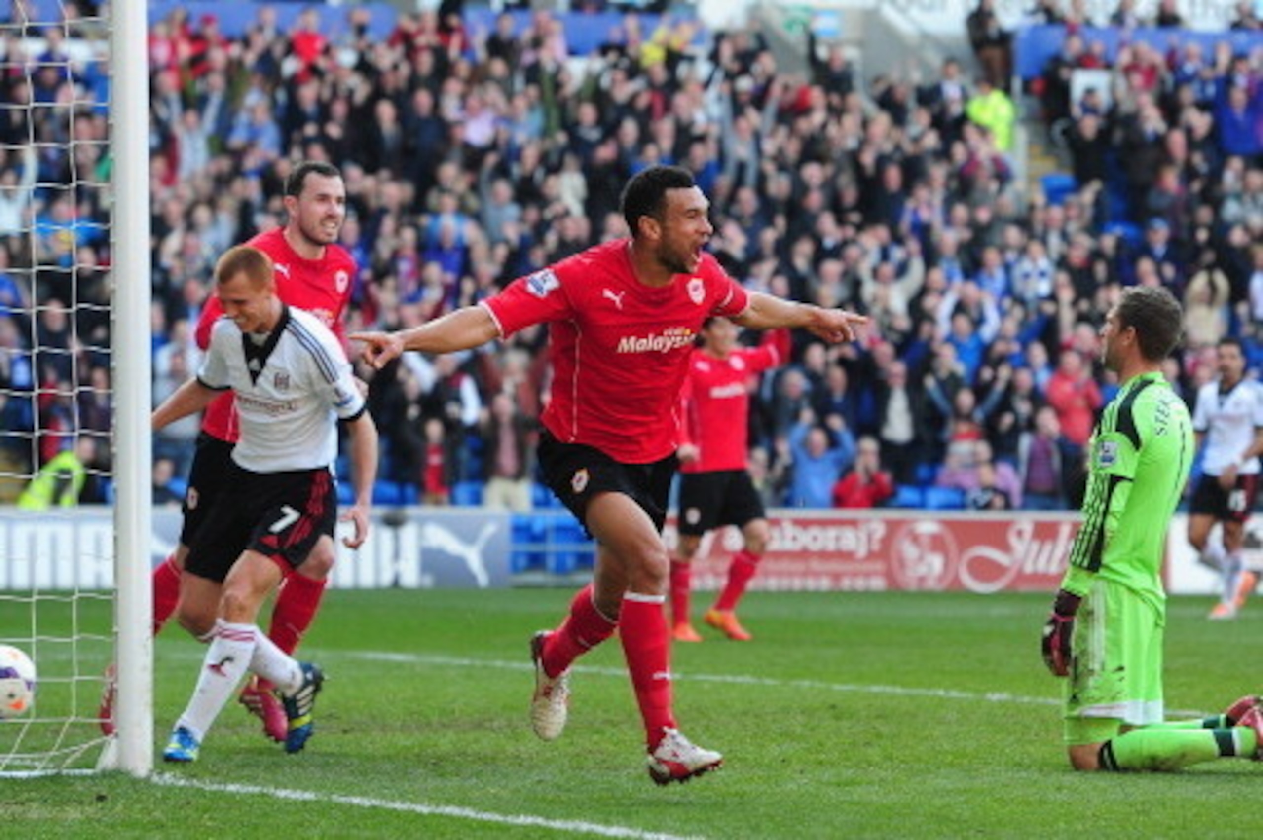 CARDIFF, WALES - MARCH 08:  Cardiff City player Steven Caulker celebrates after scoring the opening goal during the Barclays Premier league match between Cardiff City and Fulham at Cardiff City Stadium on March 8, 2014 in Cardiff, Wales.  (Photo by Stu Fo