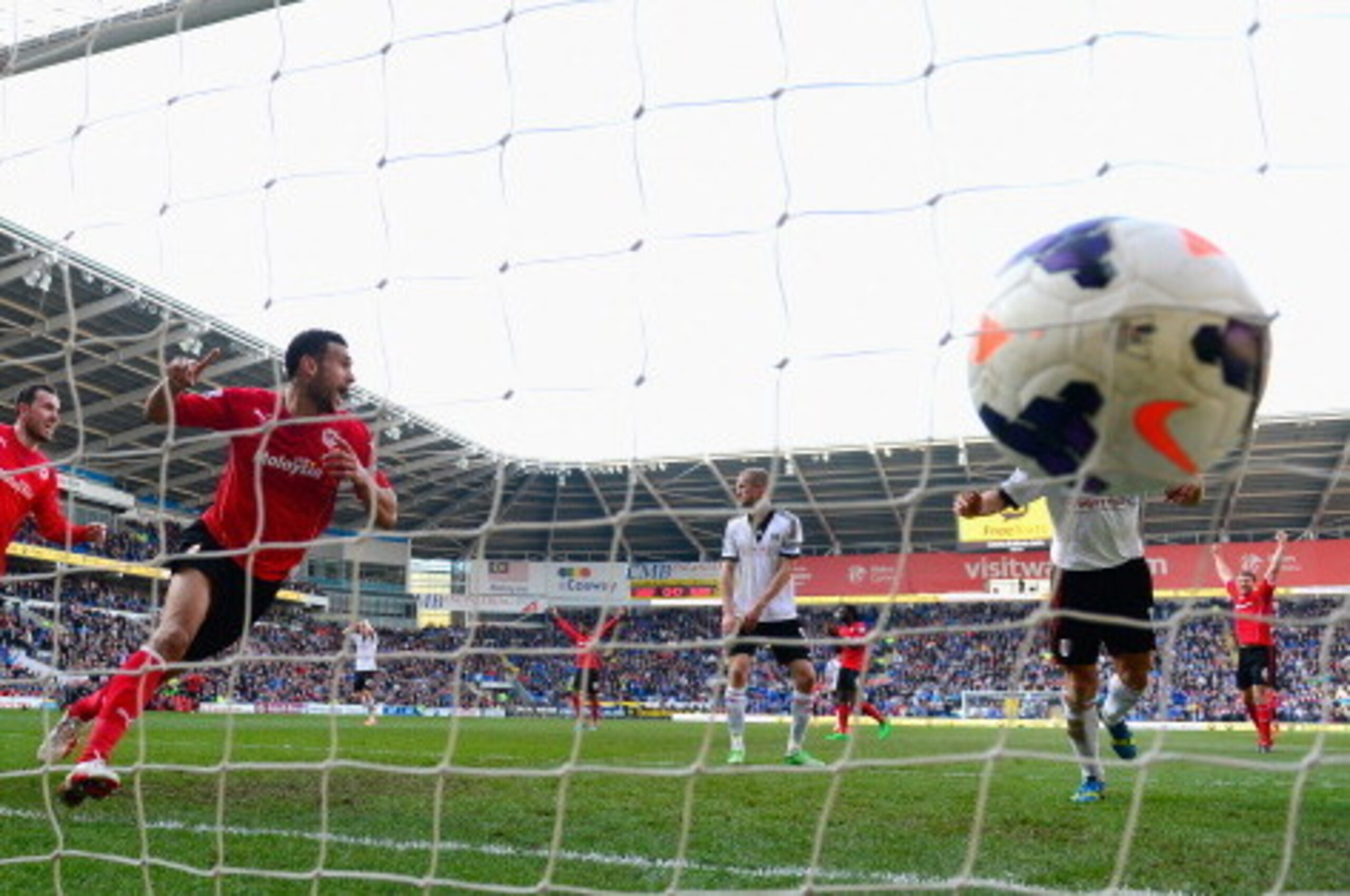 CARDIFF, WALES - MARCH 08:  Cardiff City player Steven Caulker (c) celebrates after scoring the opening goal during the Barclays Premier league match between Cardiff City and Fulham at Cardiff City Stadium on March 8, 2014 in Cardiff, Wales.  (Photo by St