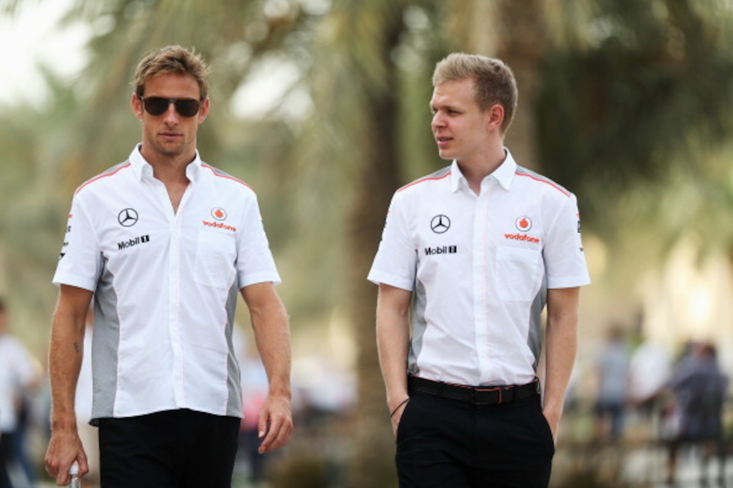 SAKHIR, BAHRAIN - APRIL 19: (L-R) Jenson Button of Great Britain and McLaren and Kevin Magnussen of Finland and McLaren walk in the paddock following practice for the Bahrain Formula One Grand Prix at the Bahrain International Circuit on April 19, 2013 i SAKHIR, BAHRAIN - APRIL 19: (L-R) Jenson Button of Great Britain and McLaren and Kevin Magnussen of Finland and McLaren walk in the paddock following practice for the Bahrain Formula One Grand Prix at the Bahrain International Circuit on April 19, 2013 i