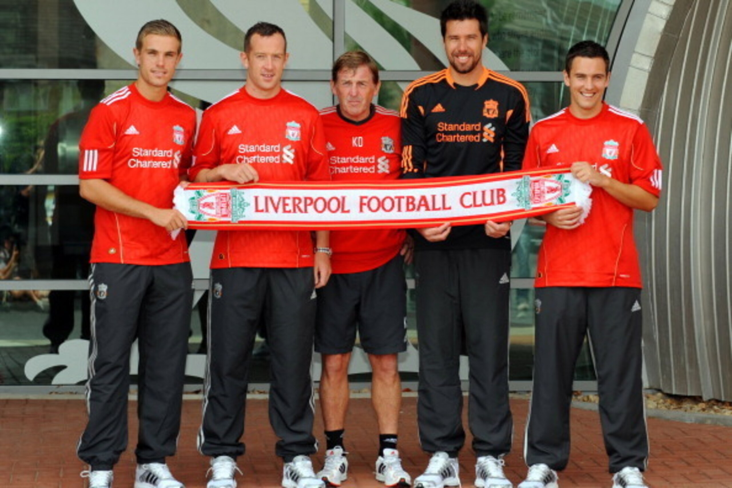 LIVERPOOL, UNITED KINGDOM - AUGUST 03:  Manager Kenny Dalglish (C) presents new signings (L-R) Jordan Henderson, Charlie Adam, Alexander Doni and Stewart Downing of Liverpool following a press conference at Melwood Training Ground on August 3, 2011 in Liv