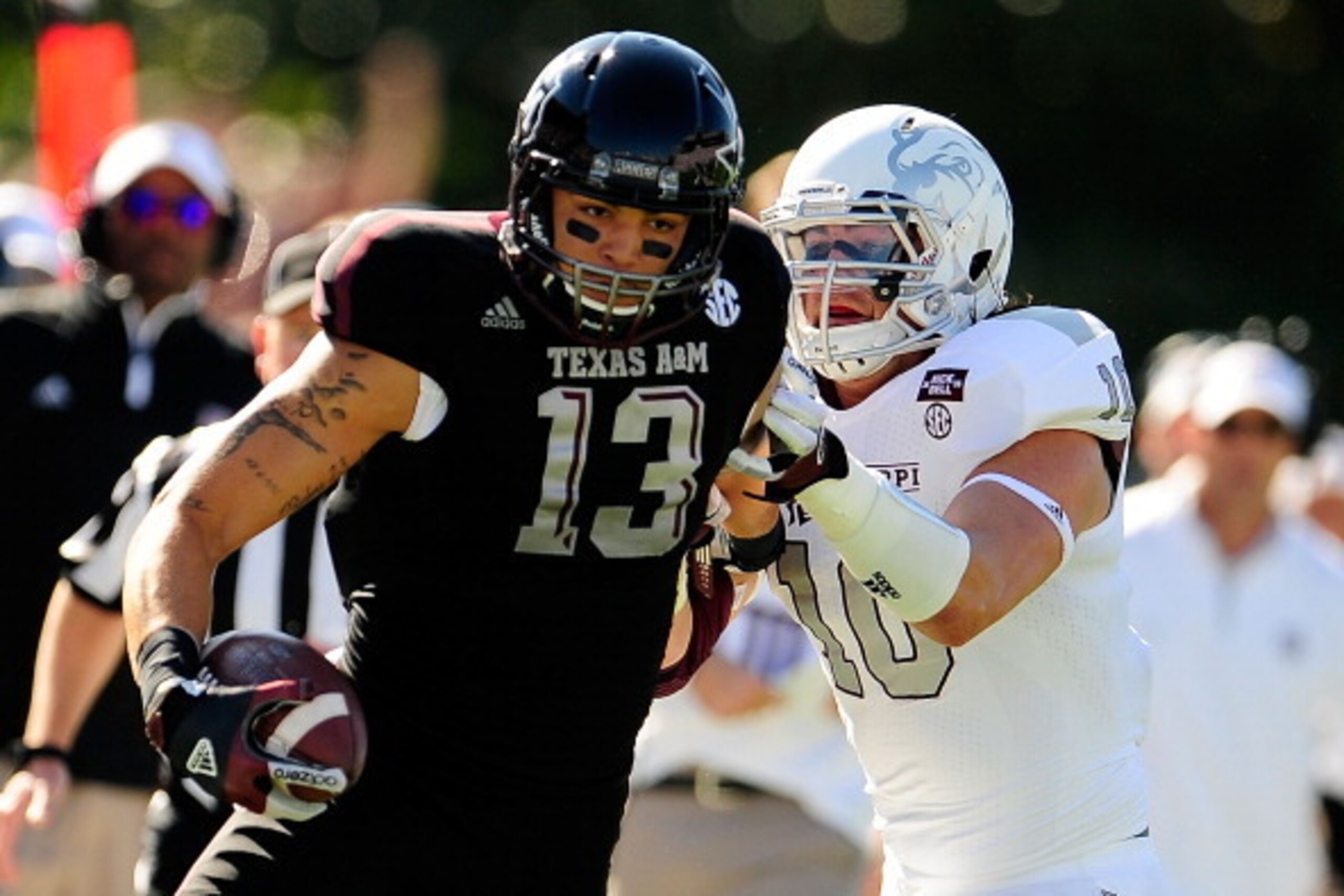 STARKVILLE, MS - NOVEMBER 03:  Mike Evans #13 of the Texas A&M Aggies avoids a tackle by Cameron Lawrence #10 of the Mississippi State Bulldogs at Wade Davis Stadium on November 3, 2012 in Starkville, Mississippi.  (Photo by Stacy Revere/Getty Images)