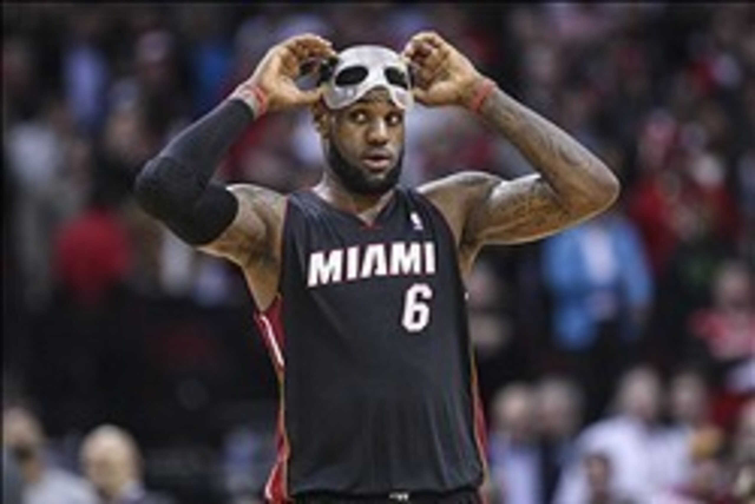 Mar 4, 2014; Houston, TX, USA; Miami Heat small forward LeBron James (6) puts on a mask during the fourth quarter/ against the Houston Rockets at Toyota Center. The Rockets defeated the Heat 106-103. Mandatory Credit: Troy Taormina-USA TODAY Sports