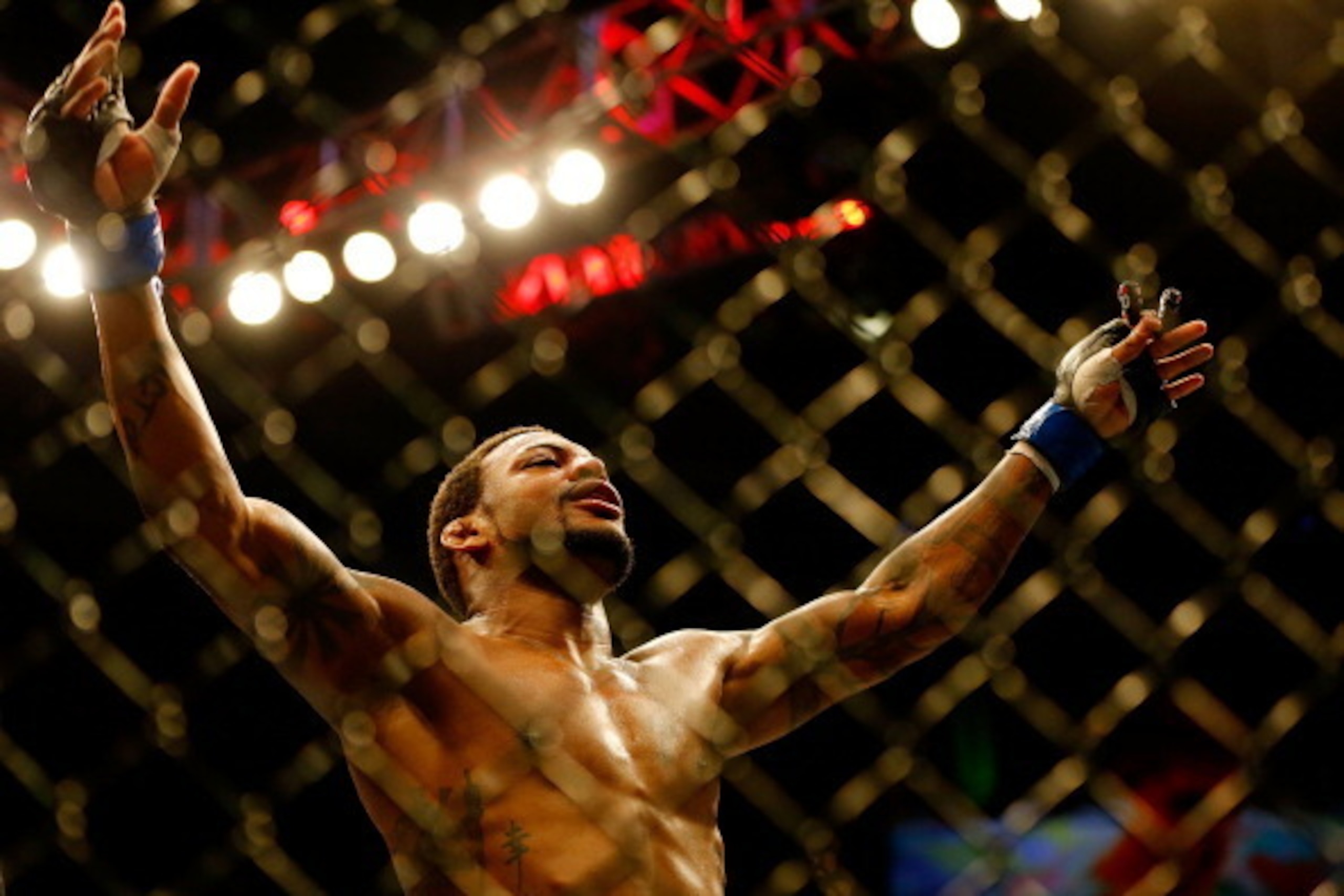 BOSTON, MA - AUGUST 17: Michael Johnson celebrates following his win against Joe Lauzon in their middleweight bout at TD Garden on August 17, 2013 in Boston, Massachusetts. (Photo by Jared Wickerham/Getty Images)
