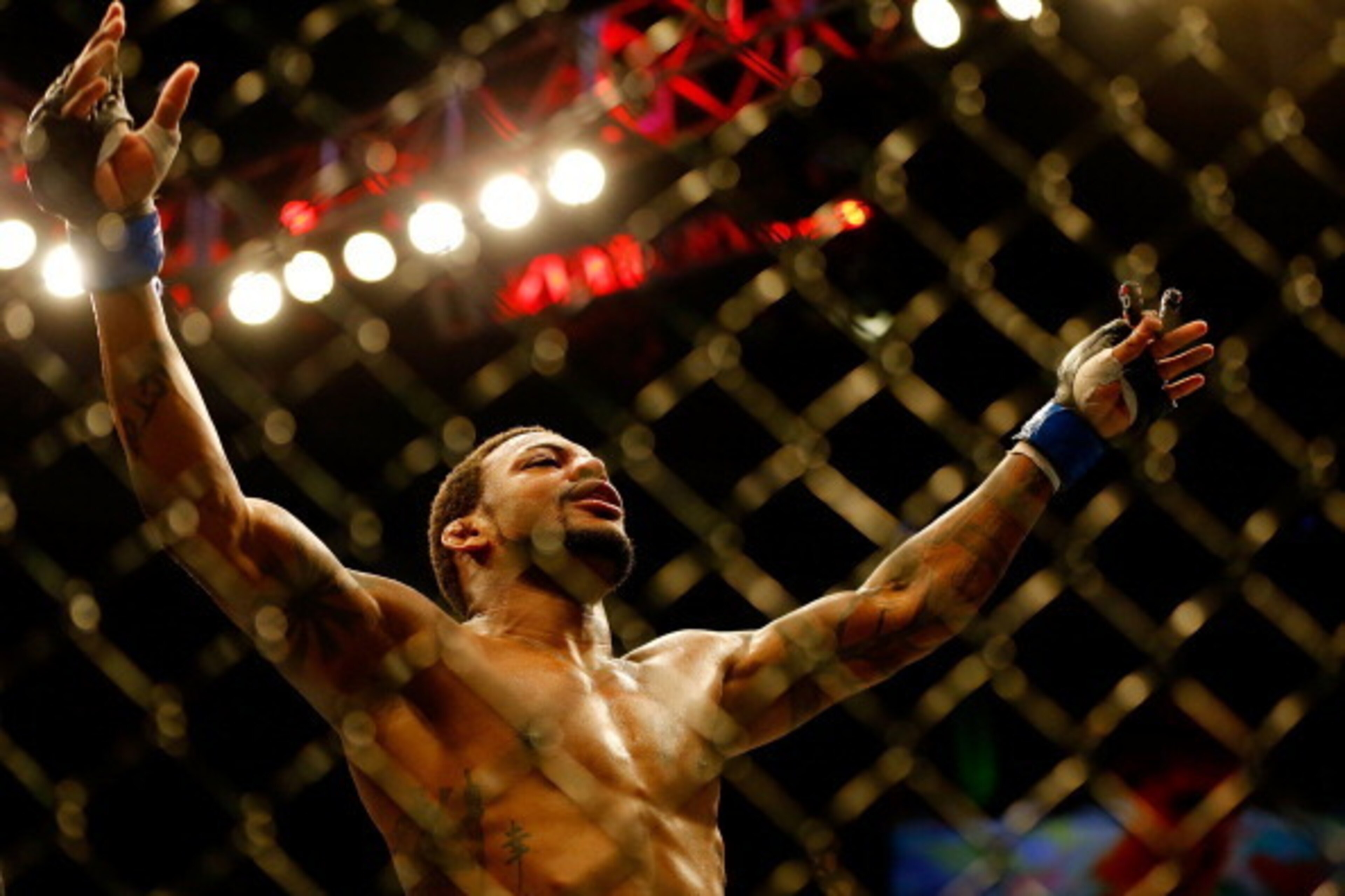BOSTON, MA - AUGUST 17: Michael Johnson celebrates following his win against Joe Lauzon in their middleweight bout at TD Garden on August 17, 2013 in Boston, Massachusetts. (Photo by Jared Wickerham/Getty Images)