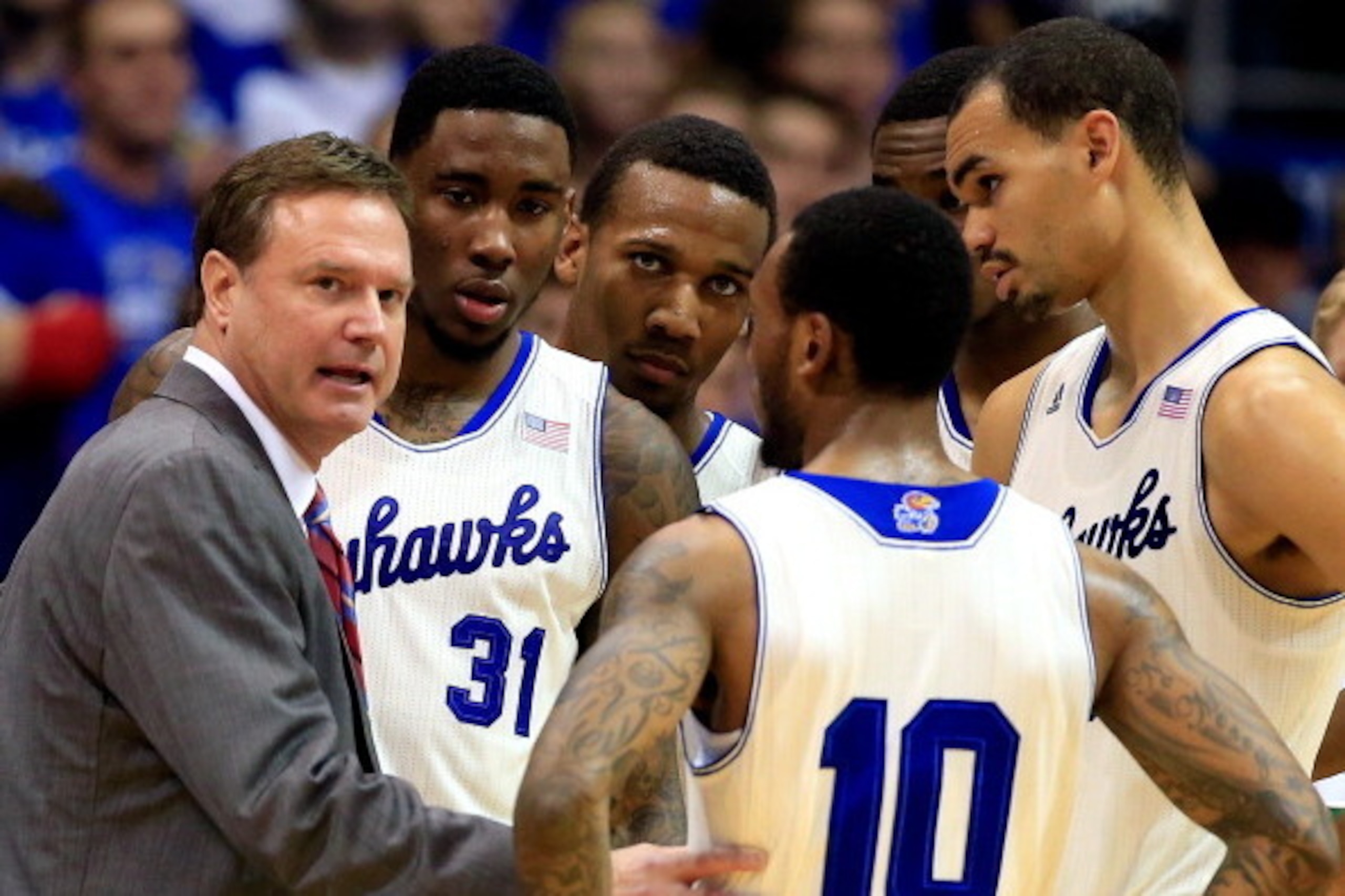 LAWRENCE, KS - JANUARY 11:  Head coach Bill Self of the Kansas Jayhawks talks with players during a timeout in the game against the Kansas State Wildcats at Allen Fieldhouse on January 11, 2014 in Lawrence, Kansas.  (Photo by Jamie Squire/Getty Images)