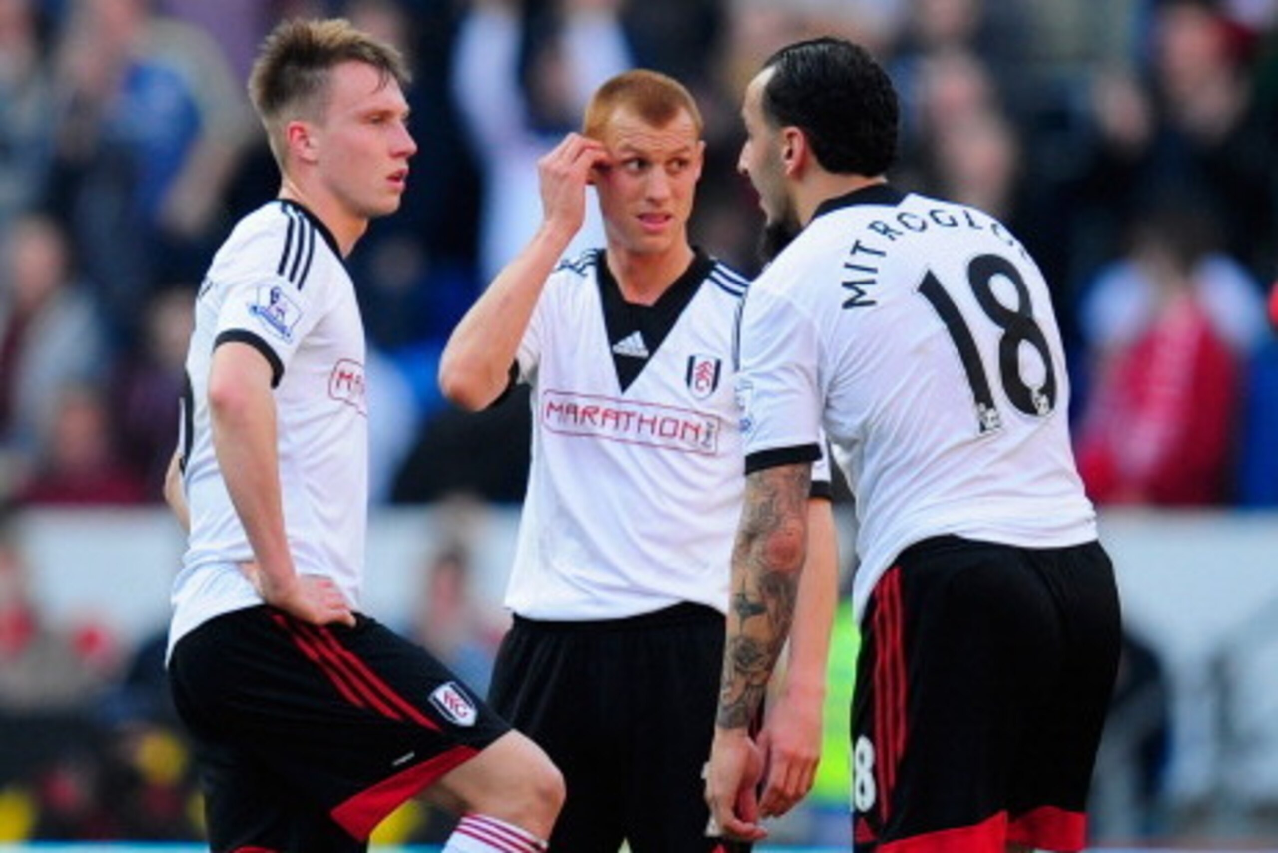 CARDIFF, WALES - MARCH 08:  Cauley Woodrow (l) Steve Sidwell (c) and Konstantinos Mitroglou of Fulham react after the third Cardiff goal during the Barclays Premier league match between Cardiff City and Fulham at Cardiff City Stadium on March 8, 2014 in C
