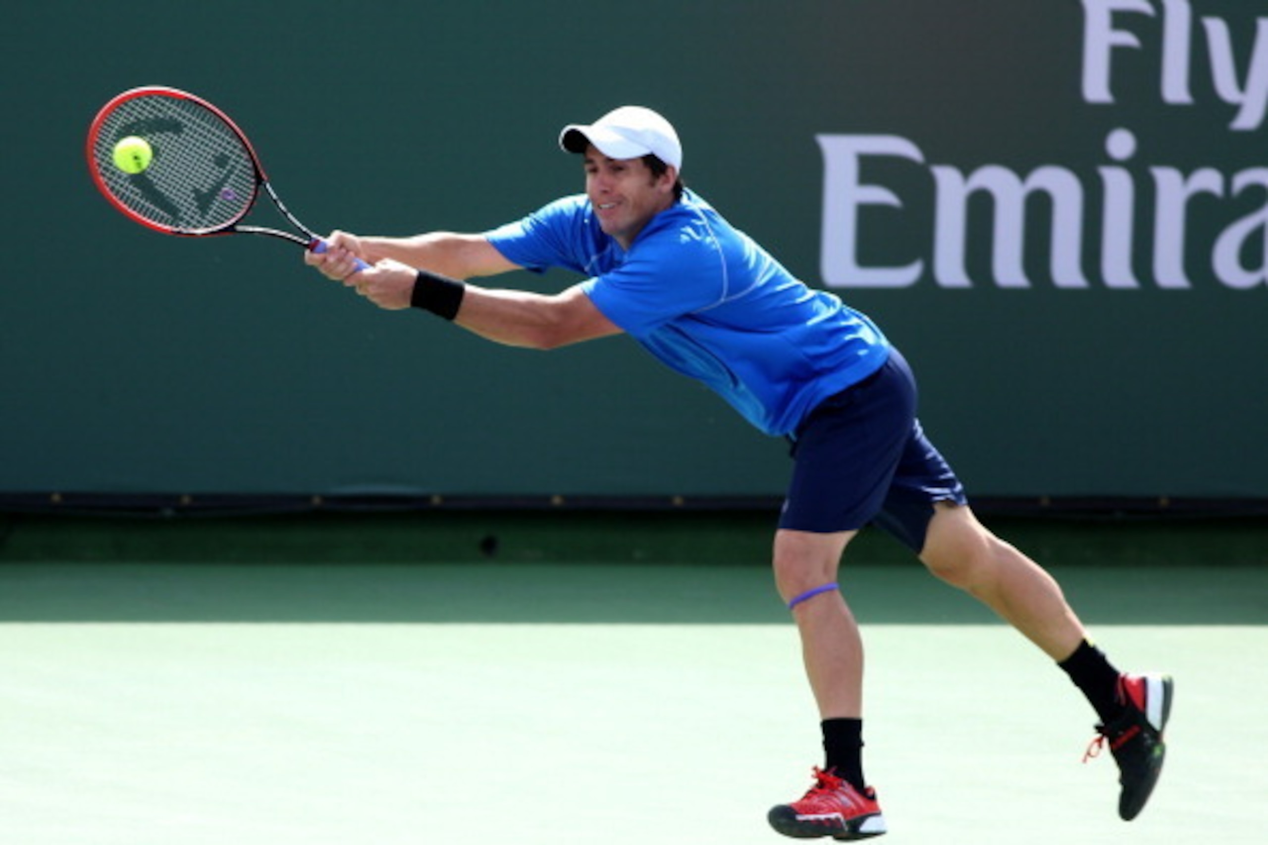 INDIAN WELLS, CA - MARCH 07:  Daniel Munoz-De La Nava of Spain hits a return to Julien Benneteau of France during the BNP Paribas Open at Indian Wells Tennis Garden on March 7, 2014 in Indian Wells, California.  Lepchenko won 6-3, 6-2.  (Photo by Stephen 