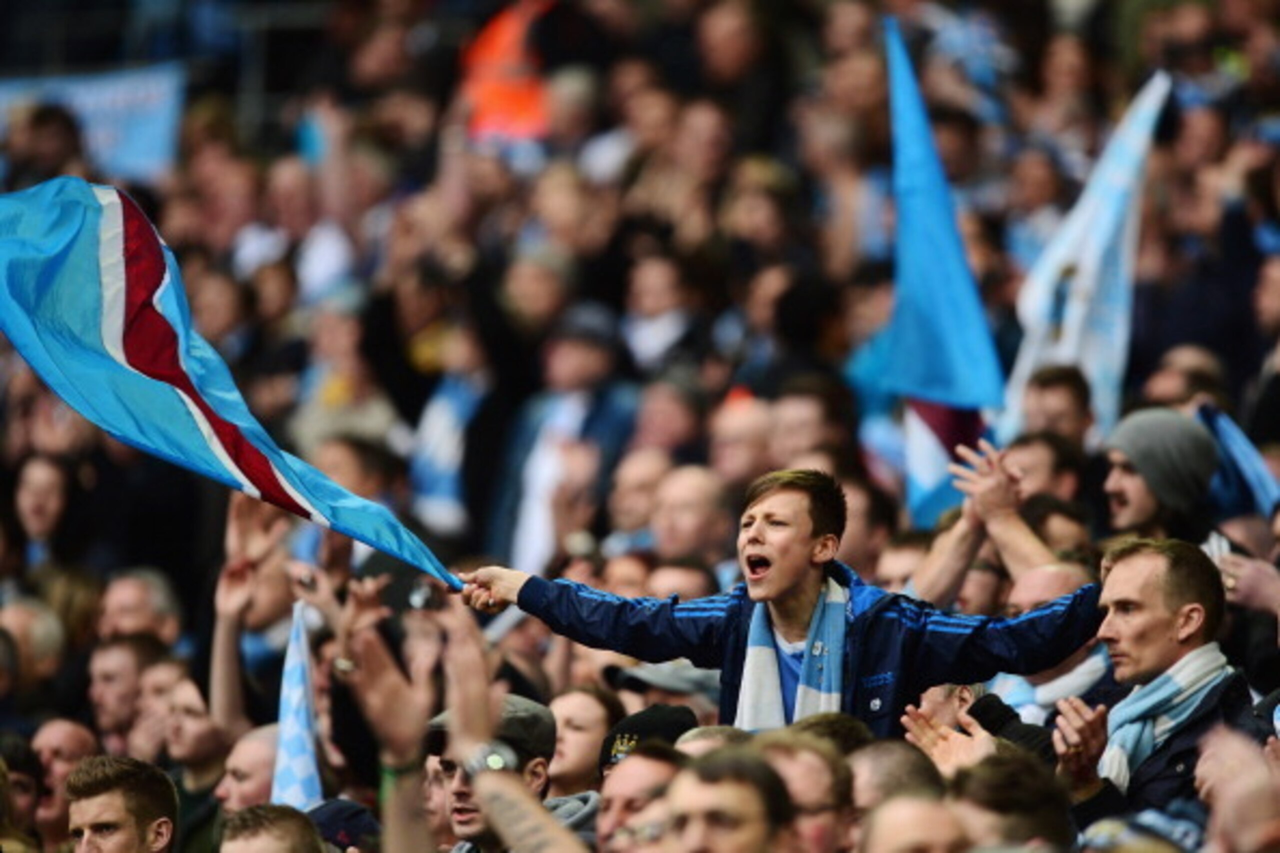 LONDON, ENGLAND - MARCH 02:  A young Manchester City fan flies the flag prior to the Capital One Cup Final between Manchester City and Sunderland at Wembley Stadium on March 2, 2014 in London, England.  (Photo by Jamie McDonald/Getty Images)