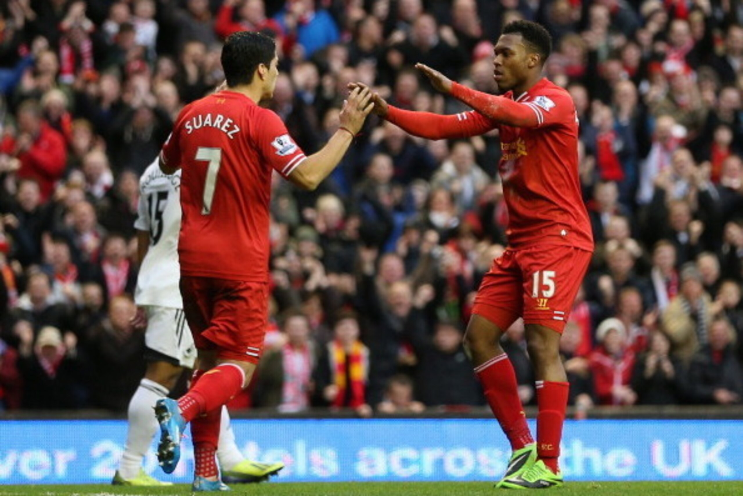 LIVERPOOL, ENGLAND - FEBRUARY 23:  Daniel Sturridge of Liverpool celebrates scoring his team's third goal with Luis Suarez during the Barclays Premier League match between Liverpool and Swansea City at Anfield on February 23, 2014 in Liverpool, England.  