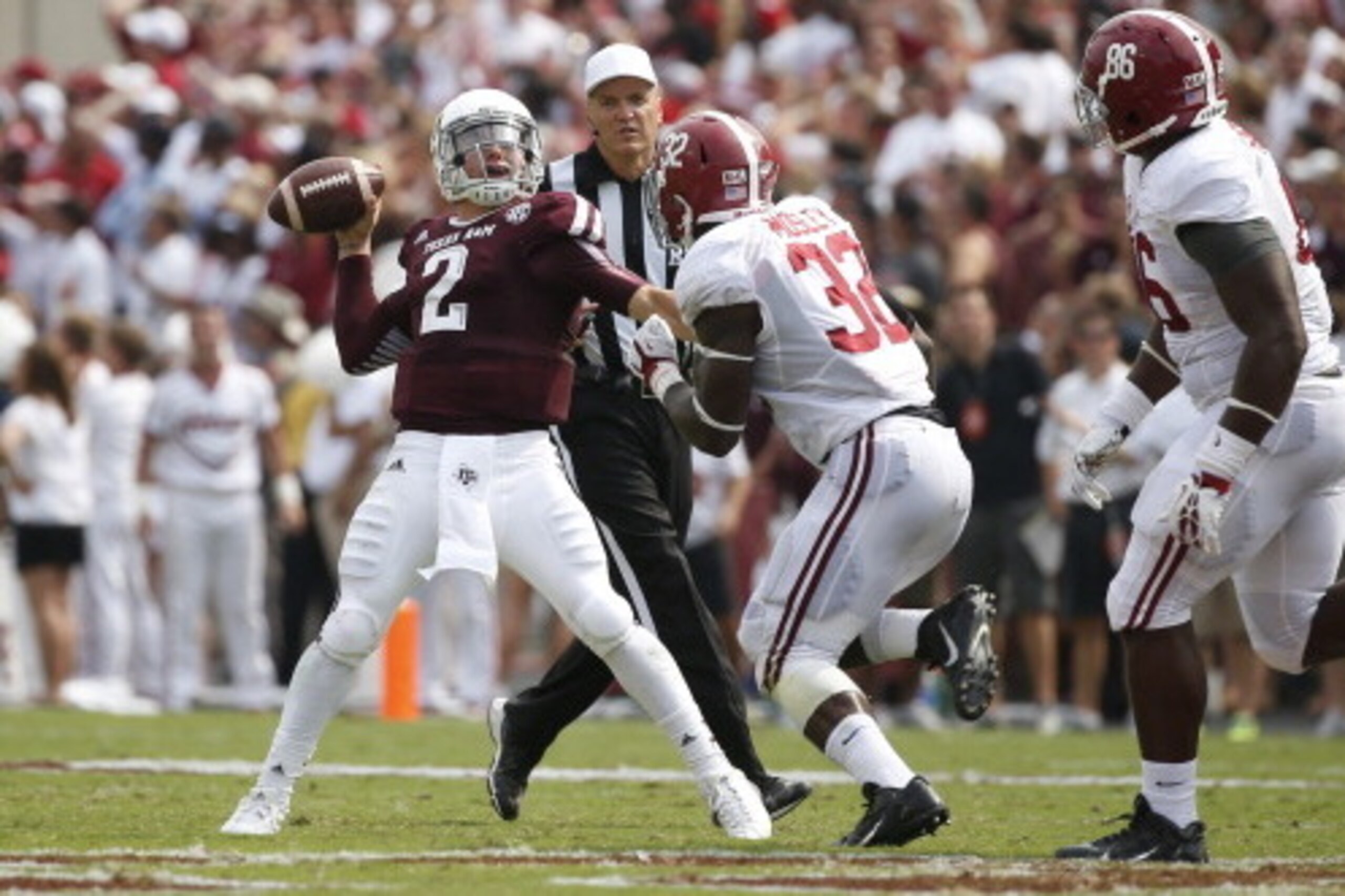 COLLEGE STATION, TX - SEPTEMBER 14:  Johnny Manziel #2 of the Texas A&M Aggies throws a pass as Brandon Wilson #36 and A'Shawn Robinson#86 of the Alabama Crimson Tide bears down on him at Kyle Field on September 14, 2013 in College Station, Texas.  (Photo