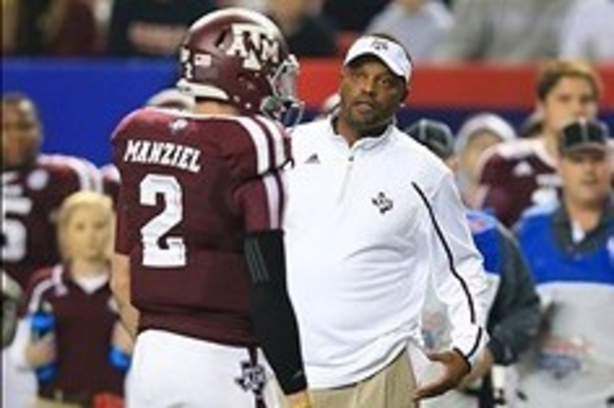 Dec 31, 2013; Atlanta, GA, USA;  Texas A&M Aggies quarterback Johnny Manziel (2) speaks with head coach Kevin Sumlin during the second quarter against the Duke Blue Devils in the 2013 Chick-fil-A Bowl at the Georgia Dome. Mandatory Credit: Daniel Shirey-U