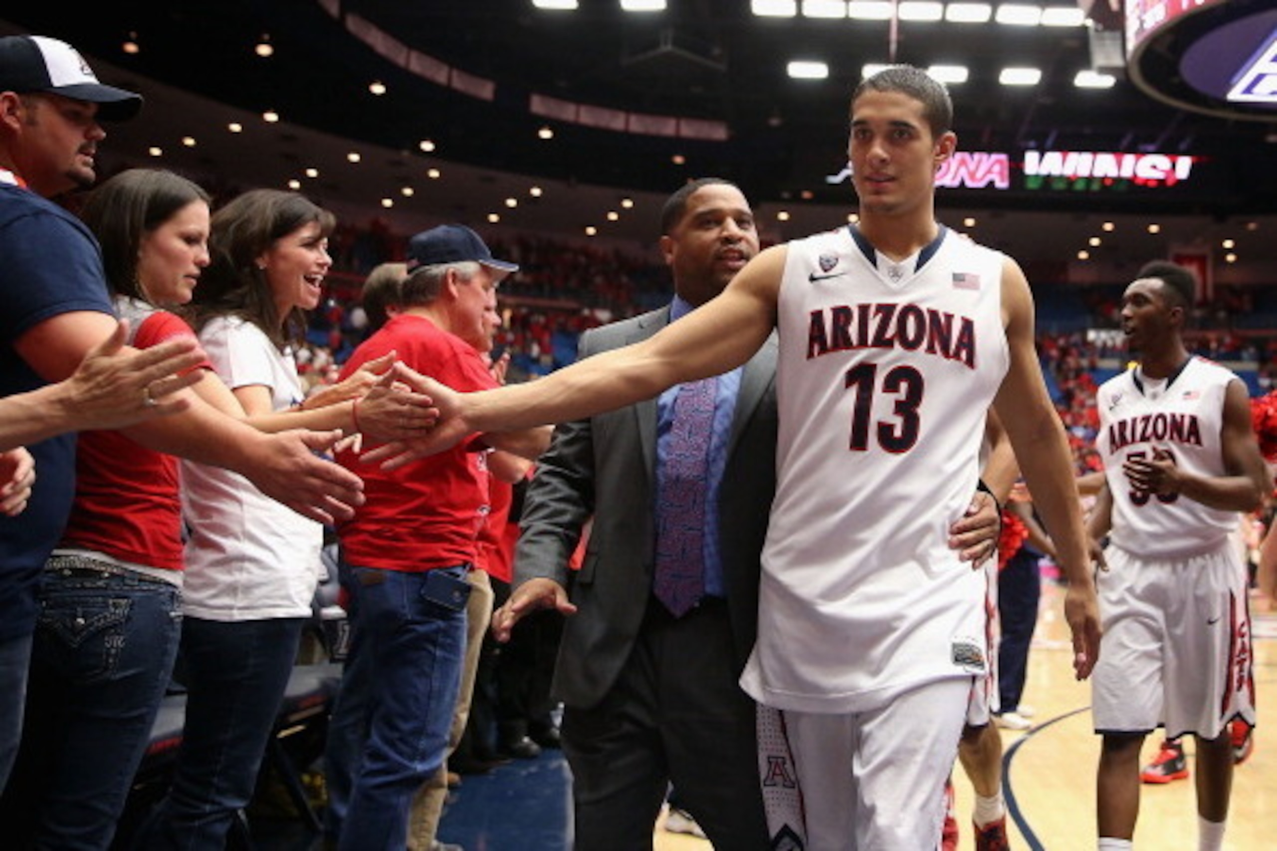 TUCSON, AZ - FEBRUARY 26: Nick Johnson #13 of the Arizona Wildcats high fives fans as he walks off the court following the college basketball game against the California Golden Bears at McKale Center on February 26, 2014 in Tucson, Arizona. The Wildcats TUCSON, AZ - FEBRUARY 26: Nick Johnson #13 of the Arizona Wildcats high fives fans as he walks off the court following the college basketball game against the California Golden Bears at McKale Center on February 26, 2014 in Tucson, Arizona. The Wildcats