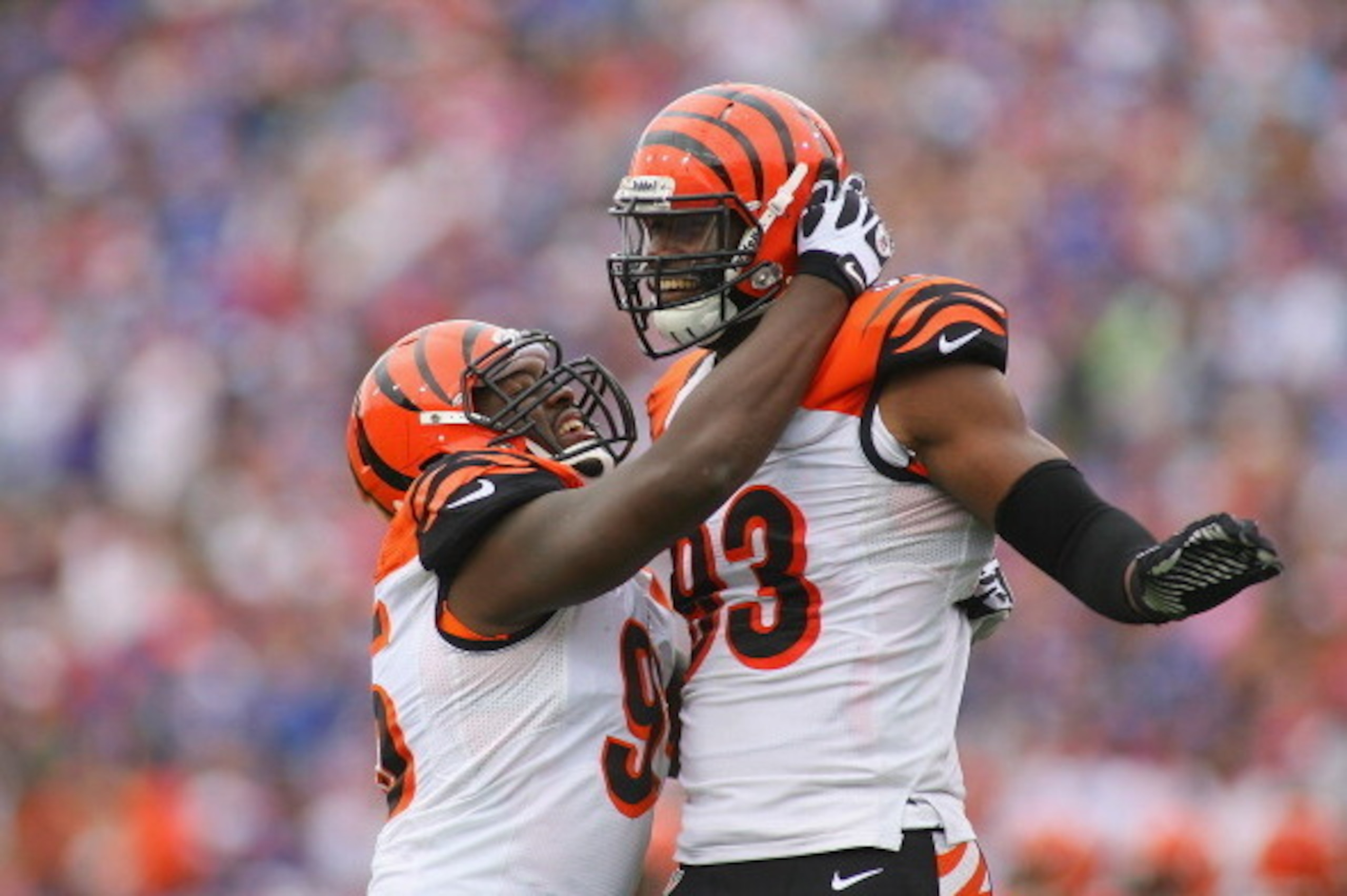 ORCHARD PARK, NY - OCTOBER 13:  Carlos Dunlap #96 and  Michael Johnson #93 of the Cincinnati Bengals celebrate a sack by Dunlap against the Buffalo Bills at Ralph Wilson Stadium on October 13, 2013 in Orchard Park, New York. Cincinnati won 27-24.  (Photo 