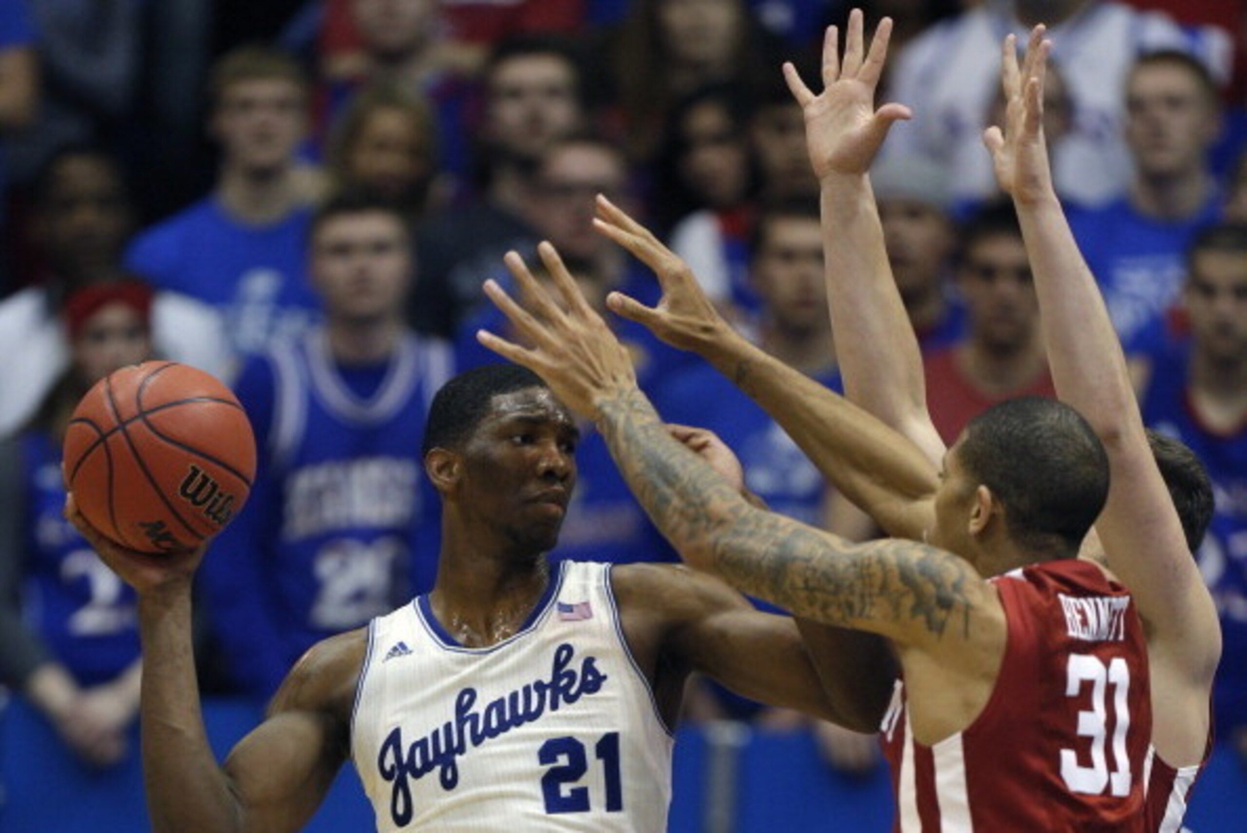 LAWRENCE, KS - FEBRUARY 24: Joel Embiid #21 of the Kansas Jayhawks looks to pass the ball against D.J. Bennett #31 of the Oklahoma Sooners in the second half at Allen Fieldhouse on February 24, 2014 in Lawrence, Kansas. Kansas won 83-75. (Photo by Ed Zu LAWRENCE, KS - FEBRUARY 24: Joel Embiid #21 of the Kansas Jayhawks looks to pass the ball against D.J. Bennett #31 of the Oklahoma Sooners in the second half at Allen Fieldhouse on February 24, 2014 in Lawrence, Kansas. Kansas won 83-75. (Photo by Ed Zu