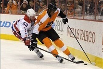 Mar 5, 2014; Philadelphia, PA, USA; Philadelphia Flyers right wing Wayne Simmonds (17) carries the puck against Washington Capitals defenseman Mike Green (52) during the first period at Wells Fargo Center. Mandatory Credit: Eric Hartline-USA TODAY Sports