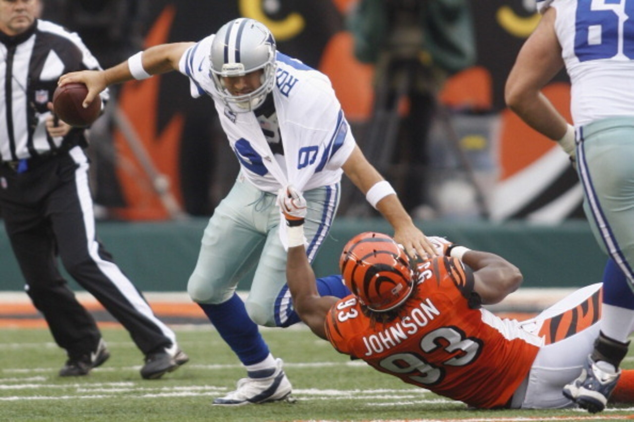 CINCINNATI, OH - DECEMBER 09:  Michael Johnson #93 of the Cincinnati Bengals sacks Tony Romo #9 of the Dallas Cowboys during their game at Paul Brown Stadium on December 9, 2012 in Cincinnati, Ohio.  The Cowboys defeated the Bengals 20-19.  (Photo by John