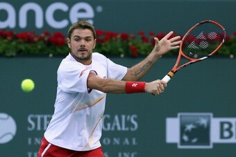 INDIAN WELLS, CA - MARCH 08:  Stanislas Wawrinka of Switzerland returns a backhand to Ivo Karlovic of Croatia during the BNP Paribas Open at Indian Wells Tennis Garden on March 8, 2014 in Indian Wells, California.  (Photo by Jeff Gross/Getty Images)