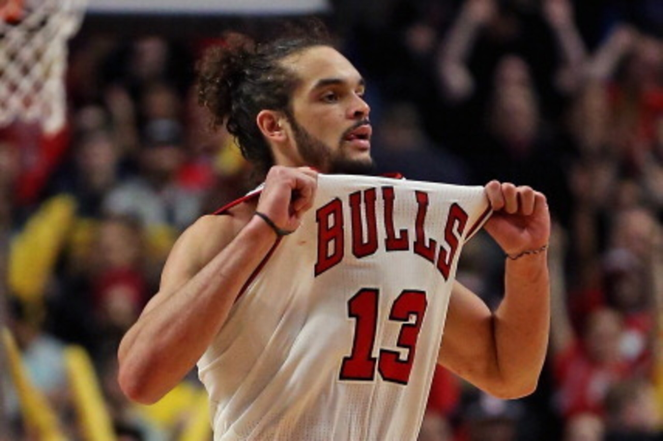 CHICAGO, IL - MARCH 09: Joakim Noah #13 of the Chicago Bulls pulls on his jersey in celebration at the end of a game against the Miami Heat at the United Center on March 9, 2014 in Chicago, Illinois. The Bulls defeated the Heat 95-88 in overtime. NOTE TO 