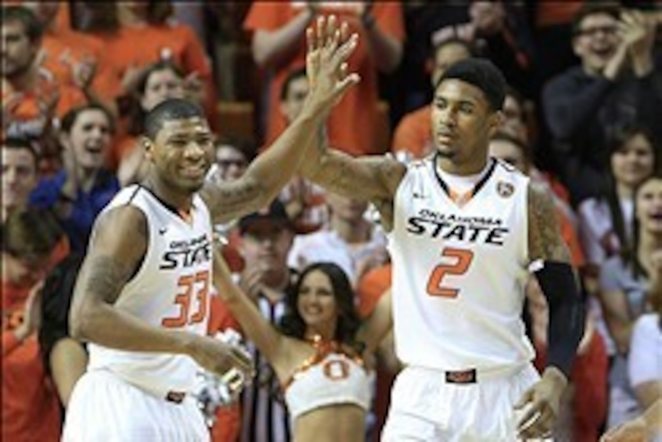 Feb 22, 2014; Stillwater, OK, USA; Oklahoma State Cowboys guard Marcus Smart (33) and wing Le'Bryan Nash celebrate after a basket against Texas Tech Red Raiders during the first half  at Gallagher-Iba Arena. Oklahoma State Cowboys won 84-62. Mandatory Cre