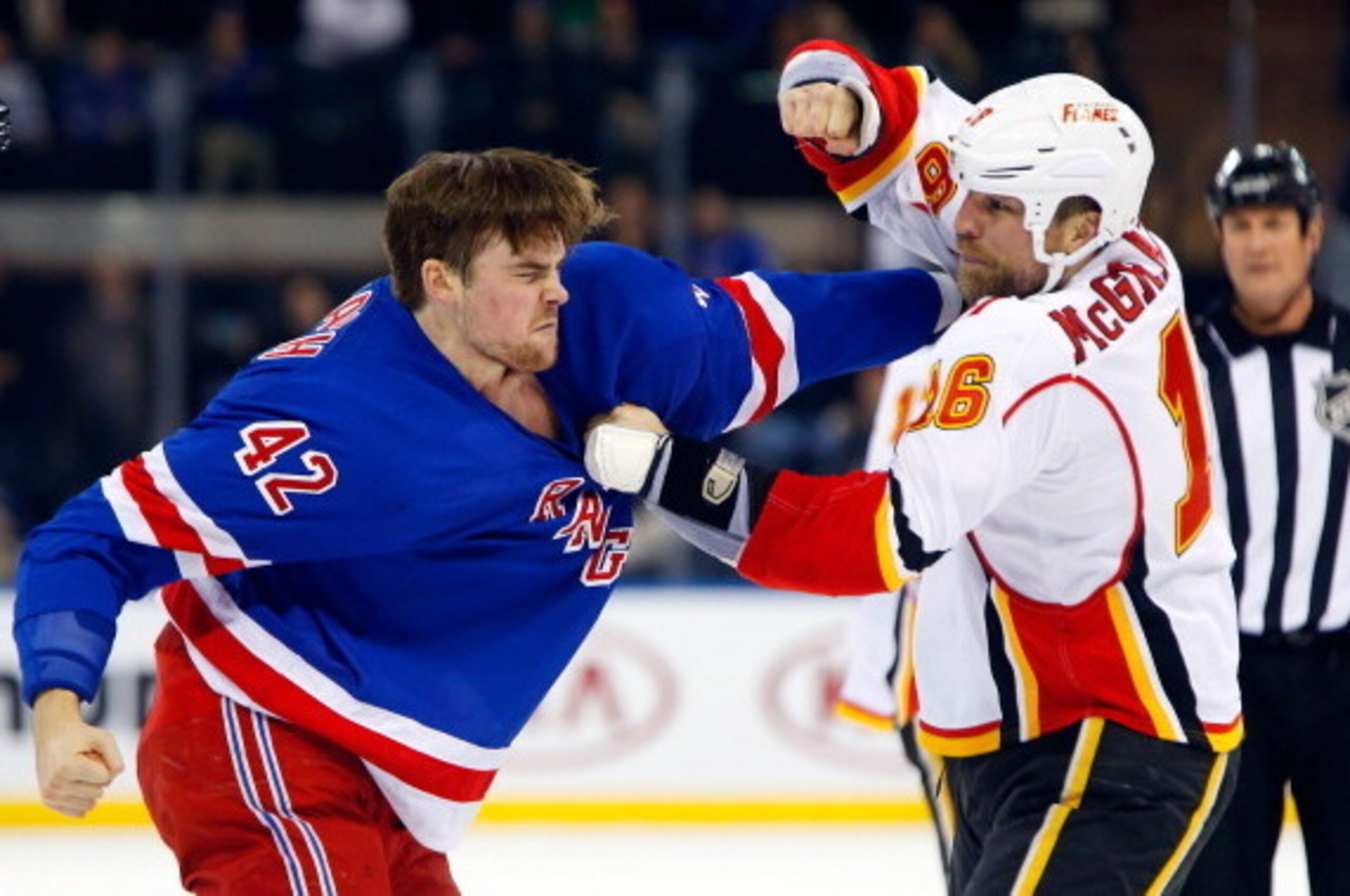 NEW YORK, NY - DECEMBER 15:  Brian McGrattan #16 of the Calgary Flames throws a punch at Dylan McIlrath #42 of the New York Rangers during their second period fight at Madison Square Garden on December 15, 2013 in New York City.  (Photo by Jim McIsaac/Get