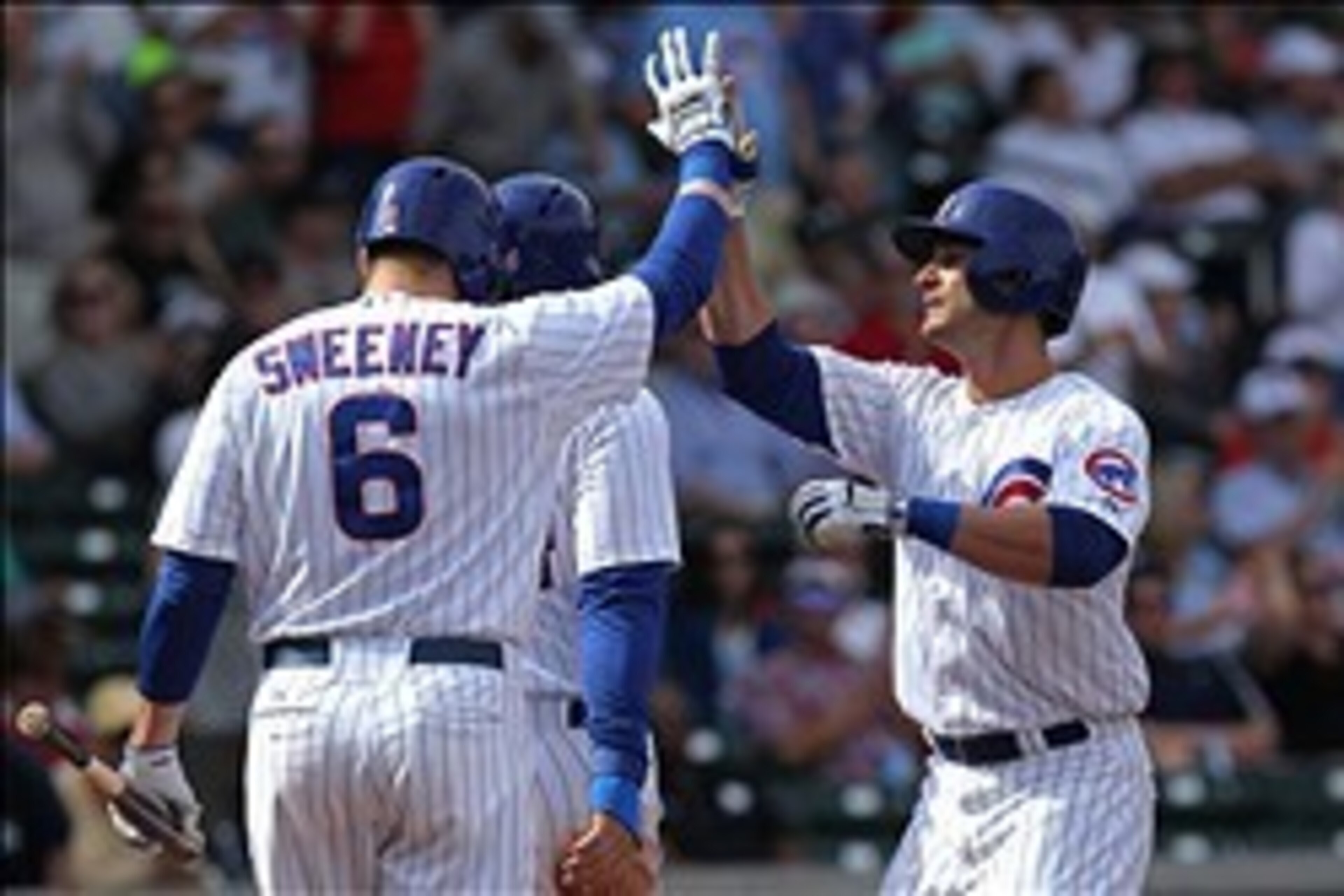 Mar 4, 2014; Mesa, AZ, USA; Chicago Cubs outfielder Justin Ruggiano (20) right is greeted at home plate after hitting a two run home run against the Oakland Athletics in the third inning of their spring training baseball game at Cubs Park. Mandatory Credi