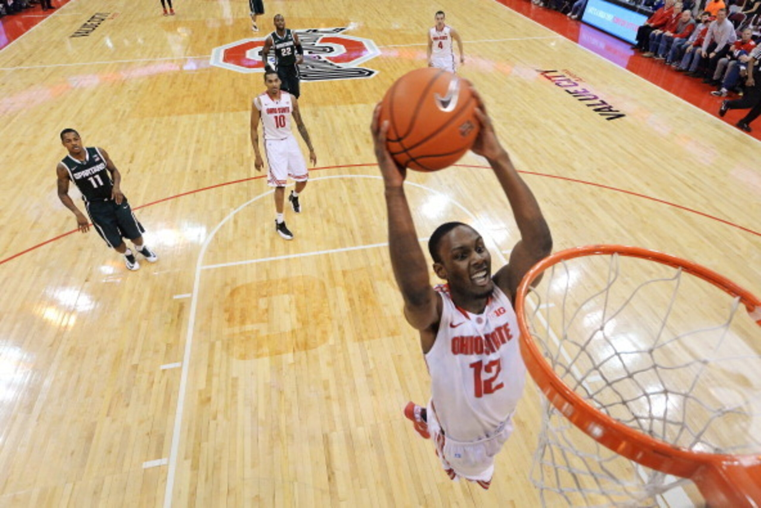 COLUMBUS, OH - MARCH 9:  Sam Thompson #12 of the Ohio State Buckeyes glides in all alone for a slam dunk in the second half against the Michigan State Spartans on March 9, 2014 at Value City Arena in Columbus, Ohio.  Ohio State defeated Michigan State 69-