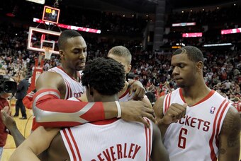 Mar 9, 2014; Houston, TX, USA; Houston Rockets center Dwight Howard (12), point guard Patrick Beverley (2), and power forward Terrence Jones (6) celebrate following the end of overtime against the Portland Trail Blazers at Toyota Center. Mandatory Credit: