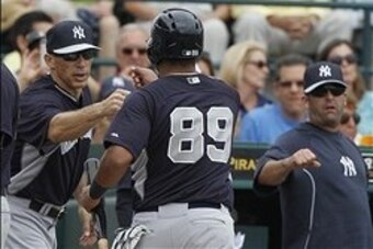 Feb 26, 2014; Bradenton, FL, USA; New York Yankees second baseman Yangervis Solarte (89) is congratulated by manager Joe Girardi (28) after he scored a run during the first inning against the Pittsburgh Pirates at McKechnie Field. Mandatory Credit: Kim Kl