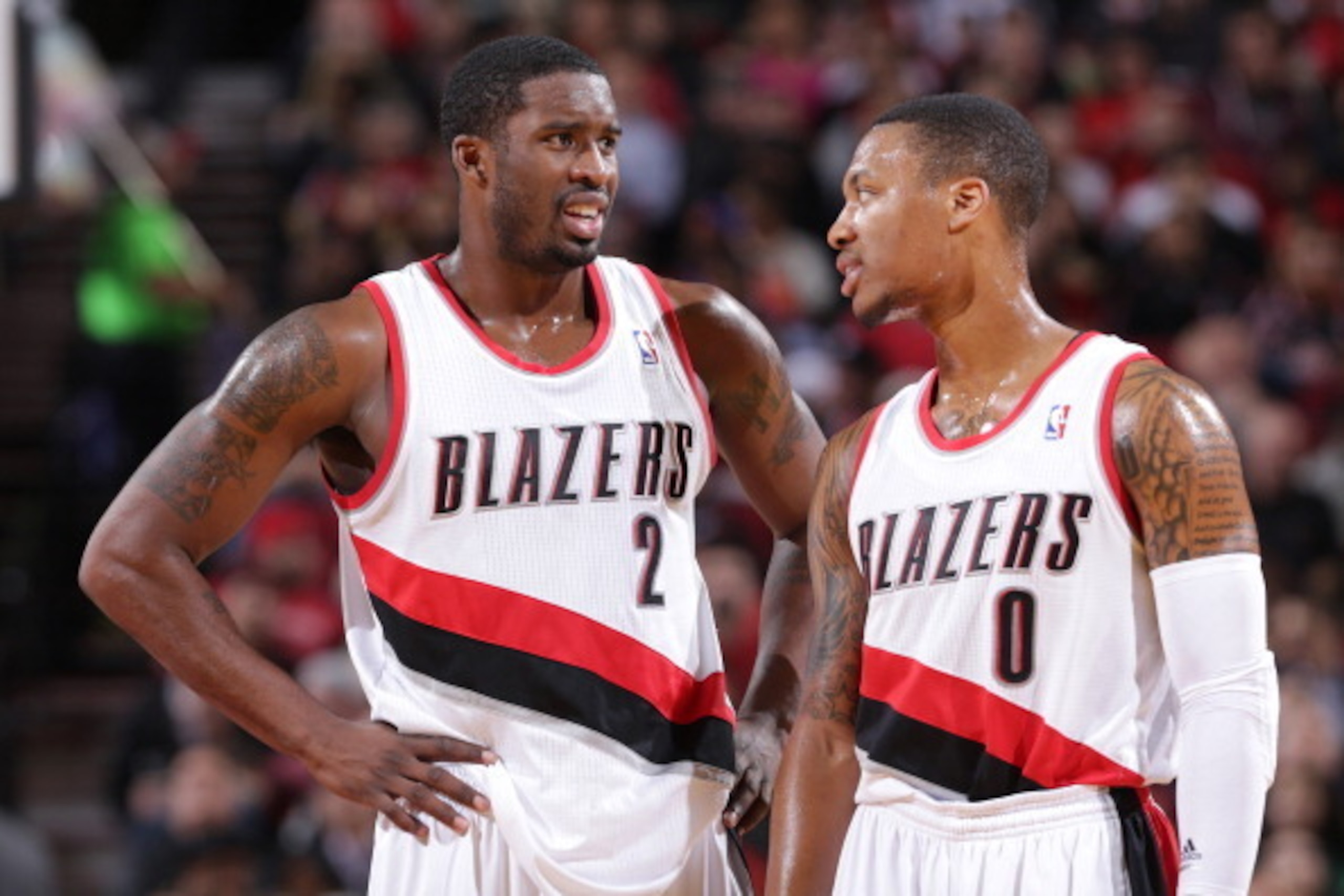 PORTLAND, OR - NOVEMBER 25:  Damian Lillard #0 and Wesley Matthews #2 of the Portland Trail Blazers stand on the court against the New York Knicks on November 25, 2013 at the Moda Center Arena in Portland, Oregon. NOTE TO USER: User expressly acknowledges