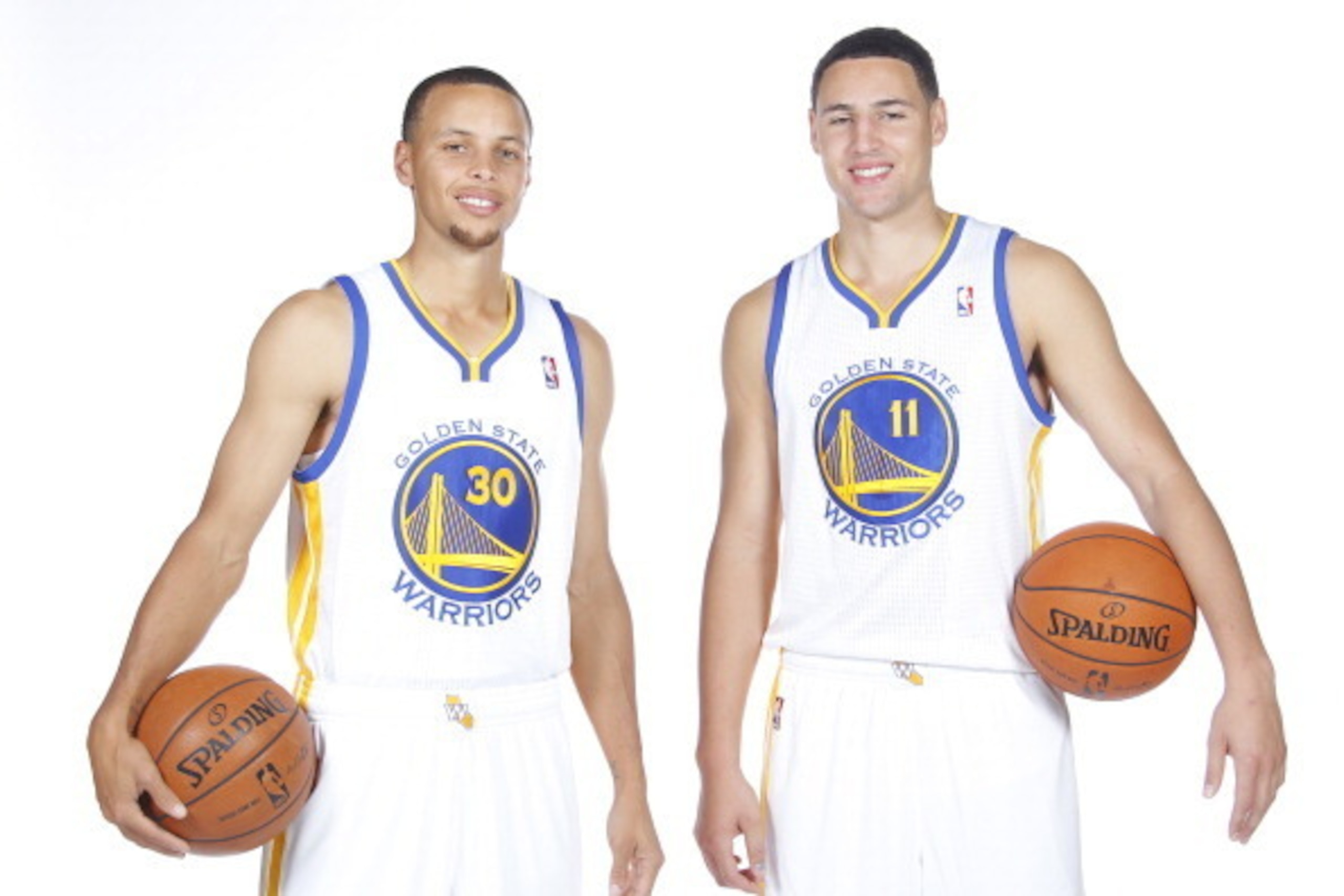OAKLAND, CA - SEPTEMBER 27:  Stephen Curry #30 and Klay Thompson #11 pose for a photo on Golden State Warriors media day held September 27, 2013 at the Warriors practice facility in Oakland, California. NOTE TO USER: User expressly acknowledges and agrees