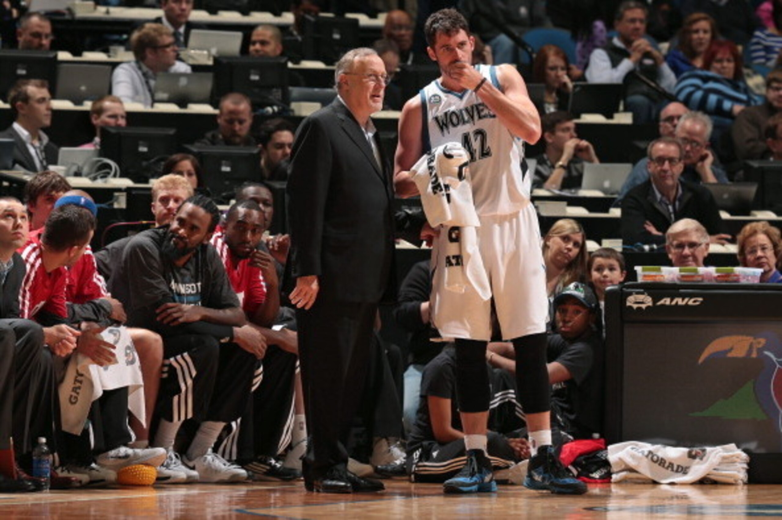 MINNEAPOLIS, MN - JANUARY 10:  Rick Adelman and Kevin Love #42 of the Minnesota Timberwolves talk during the game against the Charlotte Bobcats on January 10, 2014 at Target Center in Minneapolis, Minnesota. NOTE TO USER: User expressly acknowledges and a