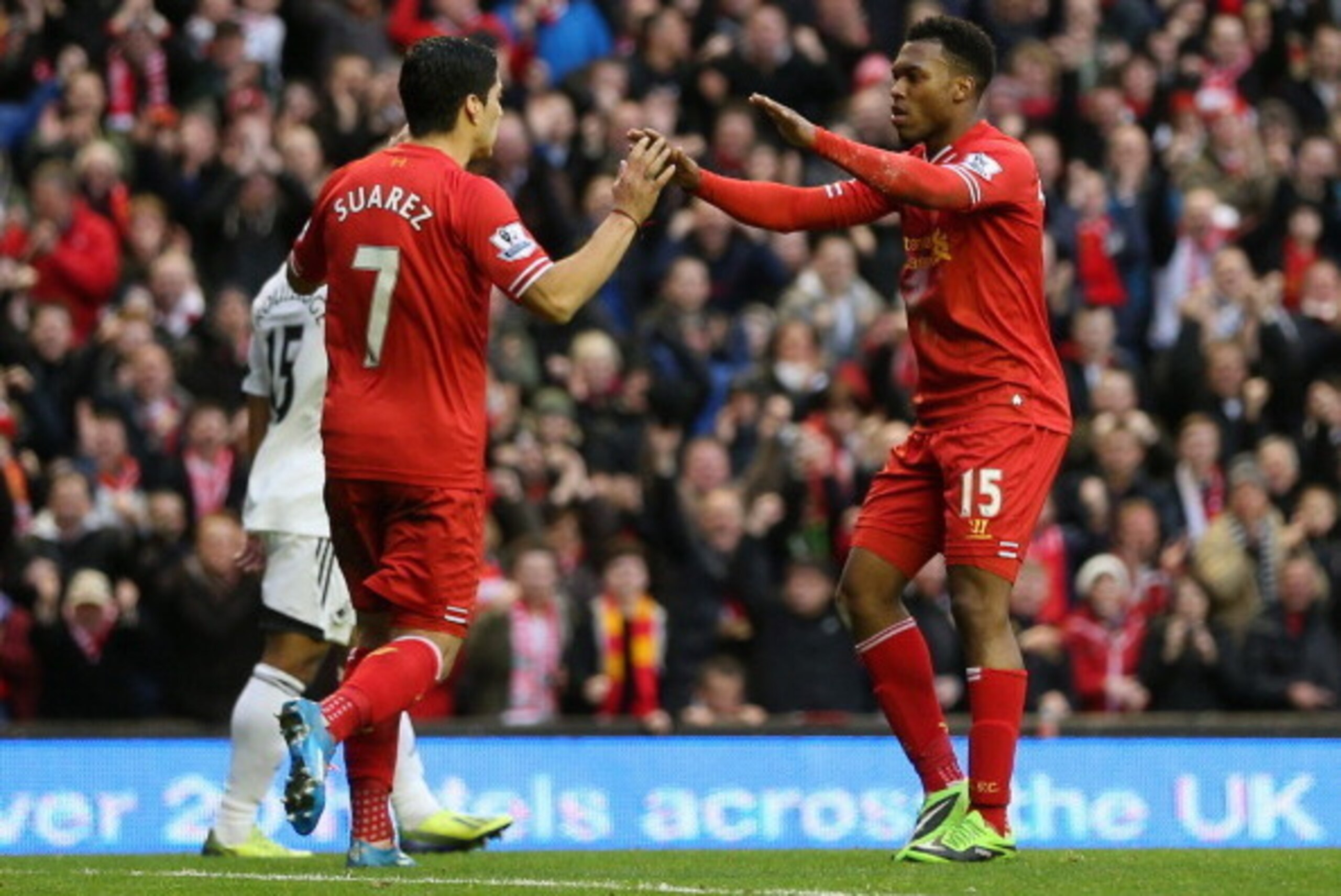 LIVERPOOL, ENGLAND - FEBRUARY 23:  Daniel Sturridge of Liverpool celebrates scoring his team's third goal with Luis Suarez during the Barclays Premier League match between Liverpool and Swansea City at Anfield on February 23, 2014 in Liverpool, England.  