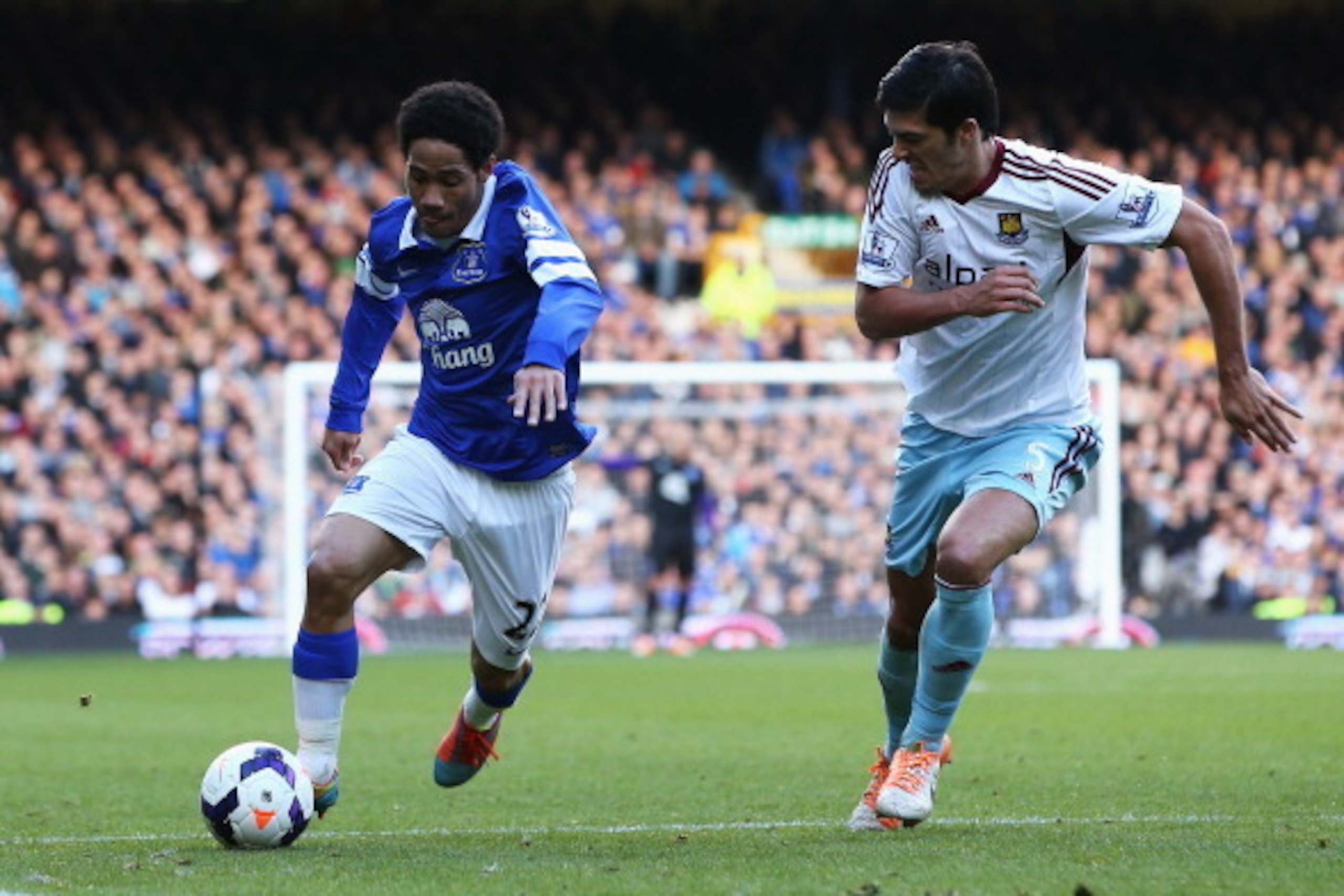 LIVERPOOL, ENGLAND - MARCH 01: Steven Pienaar of Everton takes on James Tomkins of West Ham United during the Barclays Premier League match between Everton and West Ham United at Goodison Park on March 1, 2014 in Liverpool, England.  (Photo by Jan Kruger/