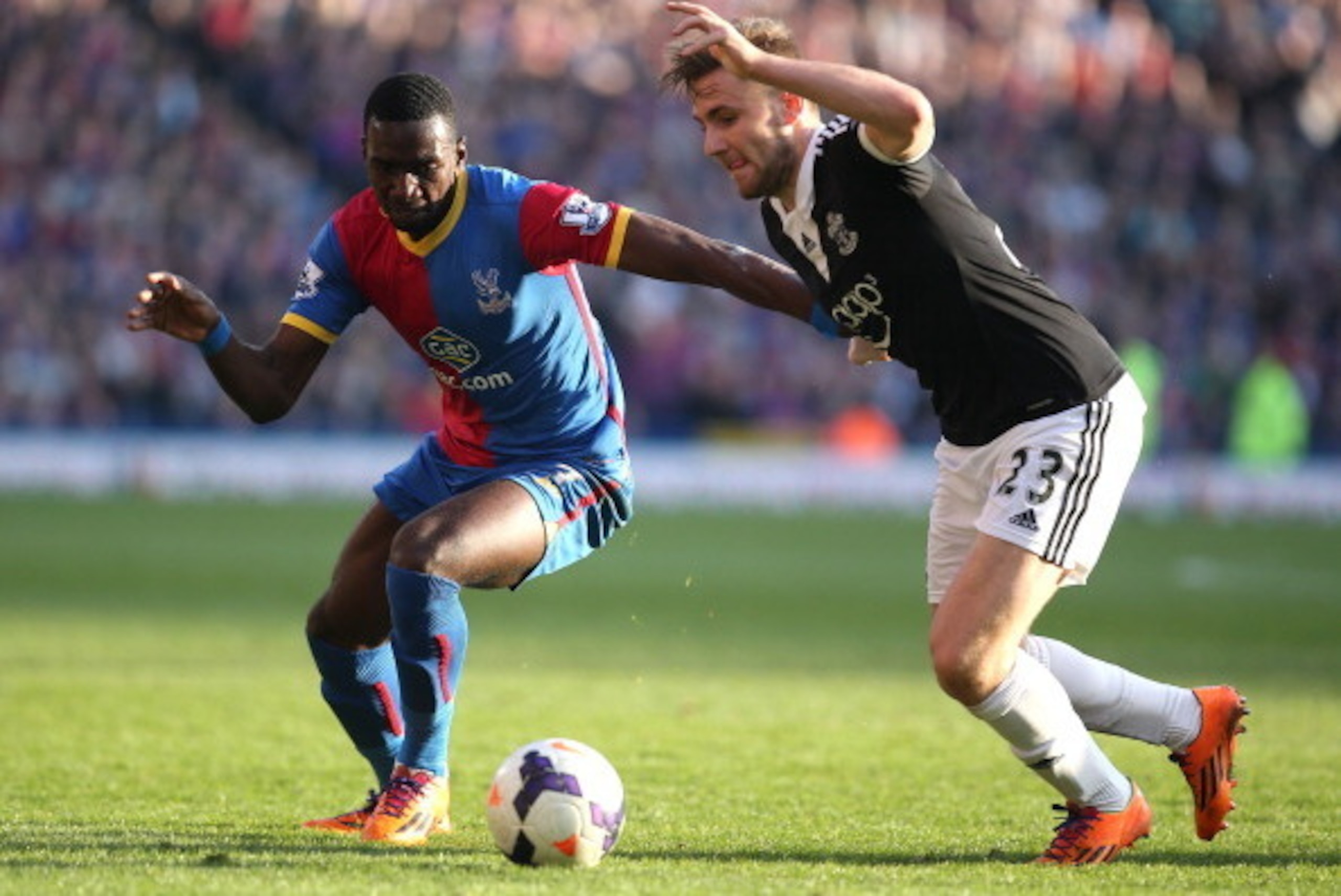 LONDON, ENGLAND - MARCH 08: Yannick Bolasie of Palace tries to get past Luke Shaw of Southampton during the Barclays Premier League match between Crystal Palace and Southampton at Selhurst Park on March 08, 2014 in London, England. (Photo by Charlie Crowh