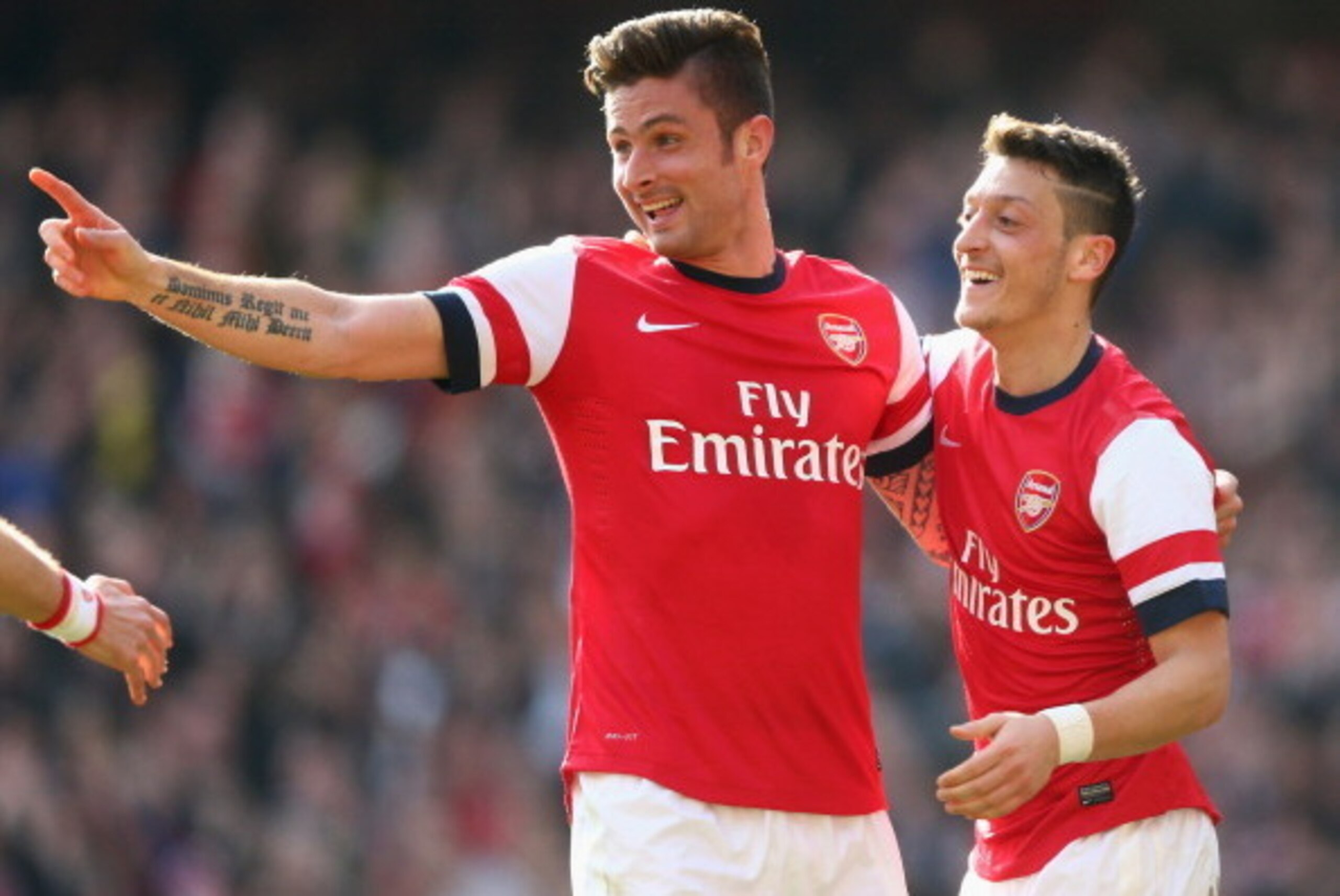 LONDON, ENGLAND - MARCH 08:  Olivier Giroud of Arsenal celebrates with teammate Mesut Oezil after scoring his team's fourth goal during the FA Cup Quarter-Final match between Arsenal and Everton at Emirates Stadium on March 8, 2014 in London, England.  (P