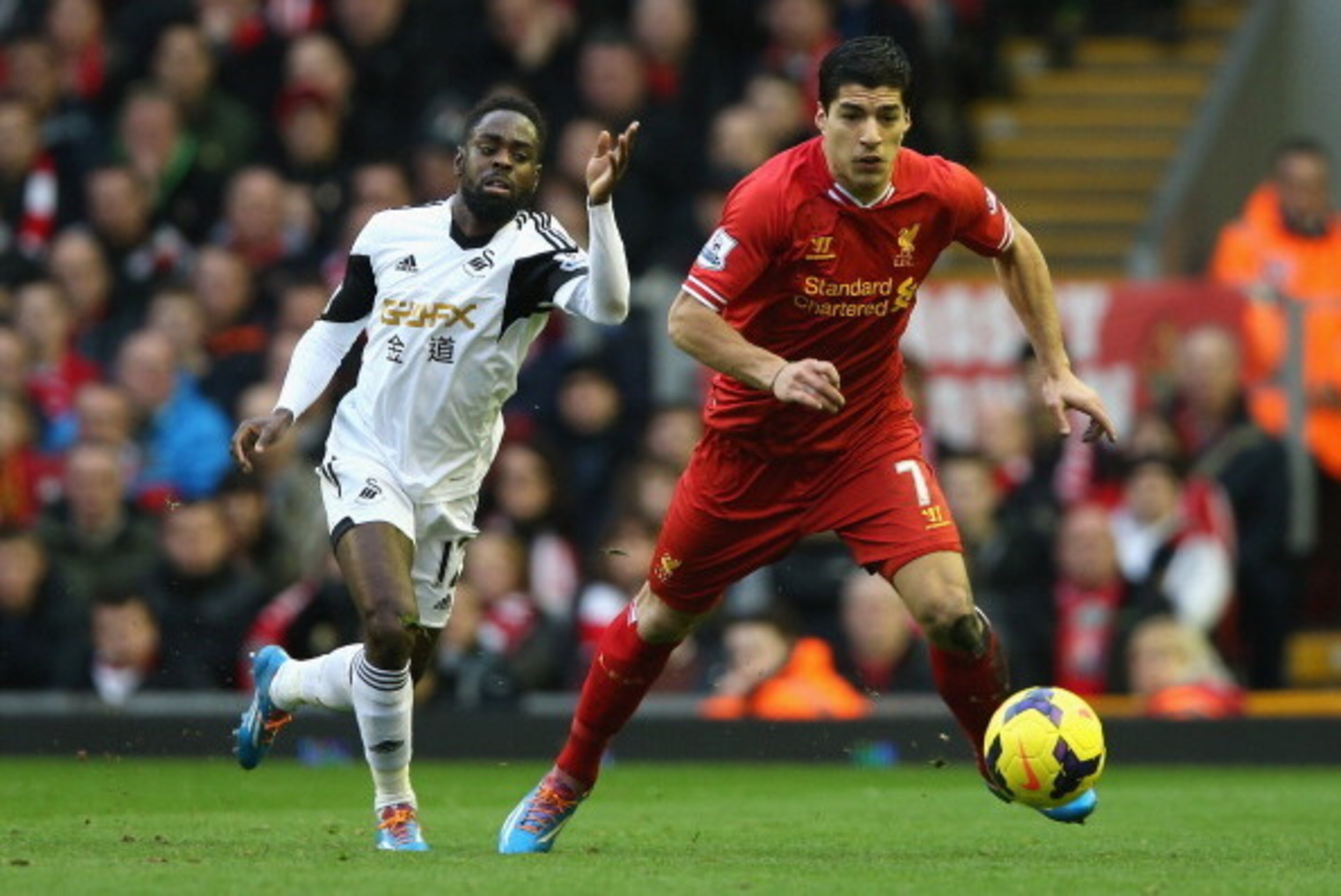 LIVERPOOL, ENGLAND - FEBRUARY 23: Luis Suarez of Liverpool competes with Nathan Dyer of Swansea City during the Barclays Premier League match between Liverpool and Swansea City at Anfield on February 23, 2014 in Liverpool, England. (Photo by Clive Bruns LIVERPOOL, ENGLAND - FEBRUARY 23: Luis Suarez of Liverpool competes with Nathan Dyer of Swansea City during the Barclays Premier League match between Liverpool and Swansea City at Anfield on February 23, 2014 in Liverpool, England. (Photo by Clive Bruns