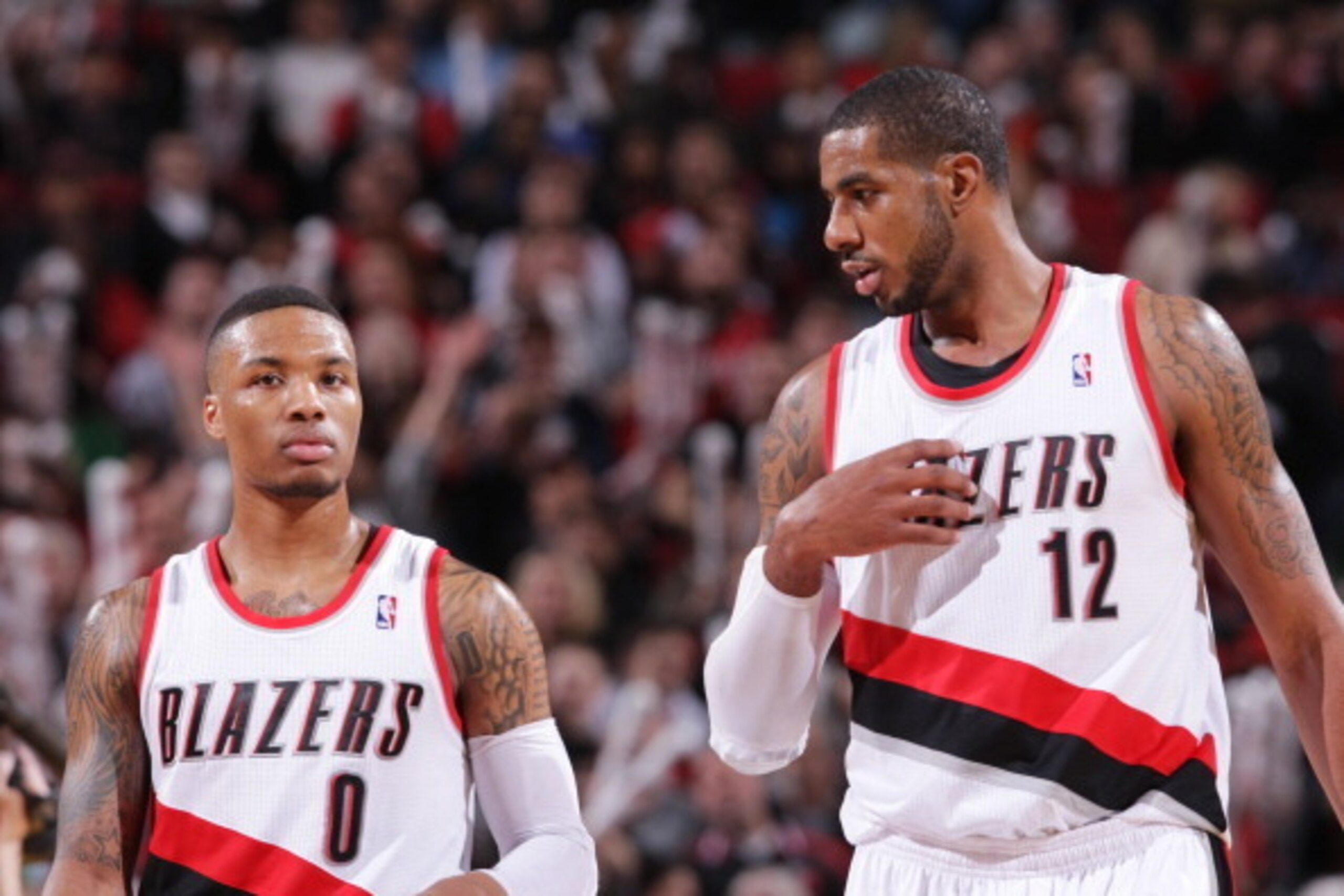 PORTLAND, OR - MARCH 1:  Damian Lillard #0 and LaMarcus Aldridge #12 of the Portland Trail Blazers walk up court  against the Denver Nuggets on March 1, 2014 at the Moda Center Arena in Portland, Oregon. NOTE TO USER: User expressly acknowledges and agree