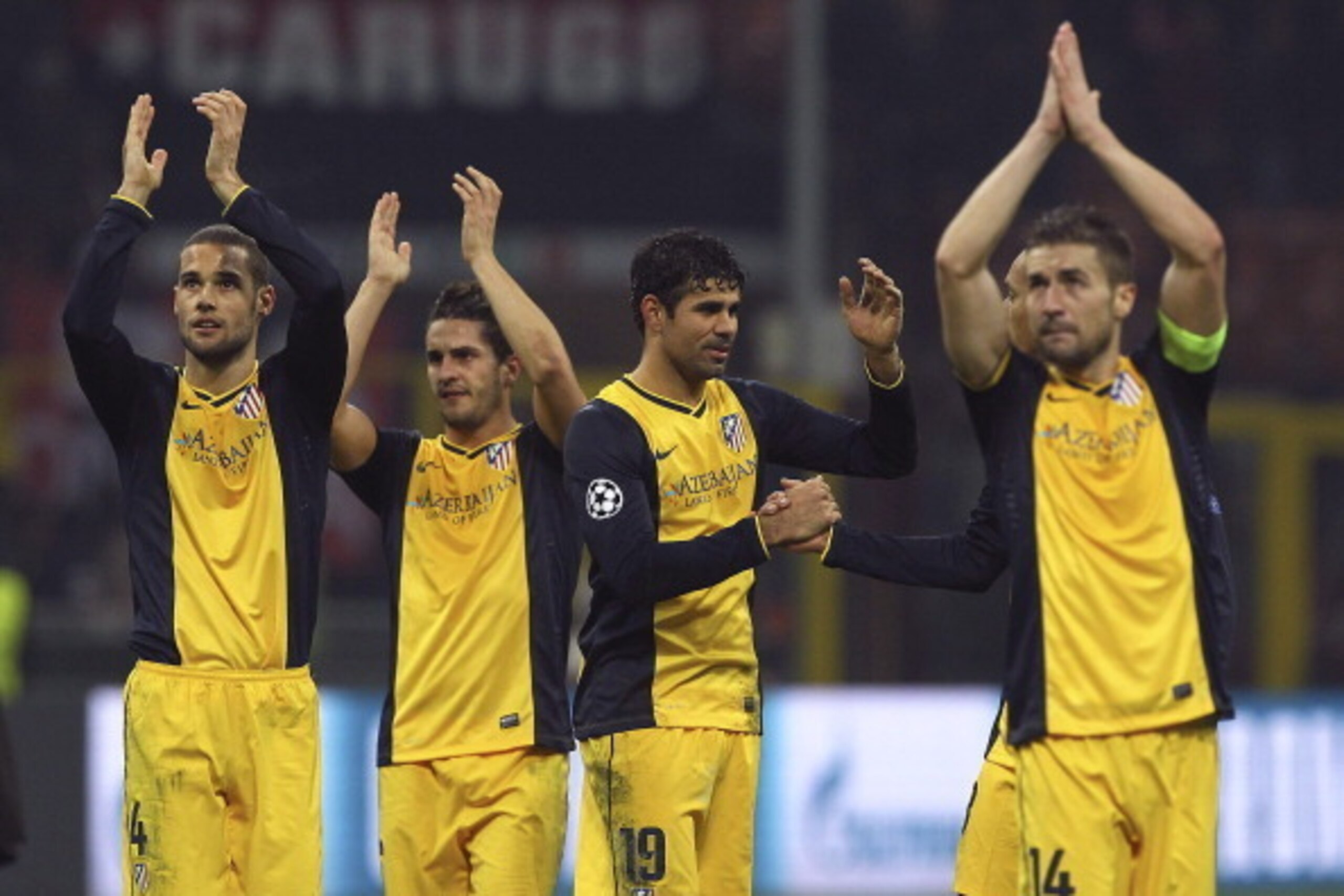 MILAN, ITALY - FEBRUARY 19:  Diego Costa #19 of Club Atletico de Madrid celebrates the victory with his team mates at the end of the UEFA Champions League Round of 16 match between AC Milan and Club Atletico de Madrid at Stadio Giuseppe Meazza on February