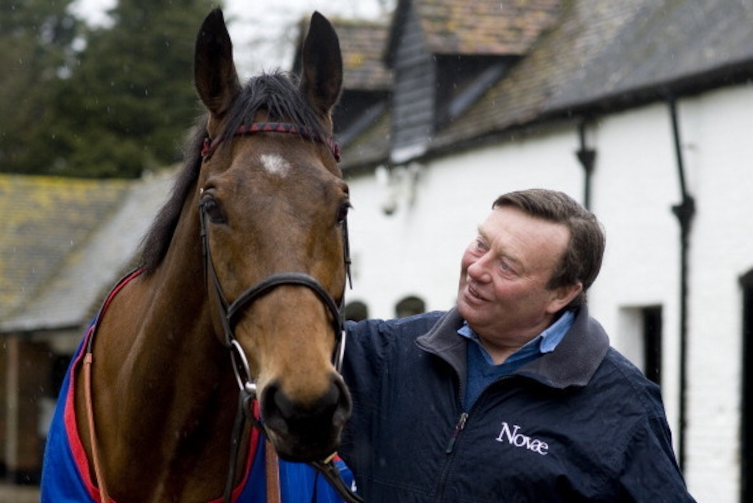 LAMBOURN, ENGLAND - MARCH 16:  Nicky Henderson poses with Cheltenham Gold Cup winner Bobs Worth at Seven Barrows Stables on March 16, 2013 in Lambourn, England. (Photo by Alan Crowhurst/Getty Images)